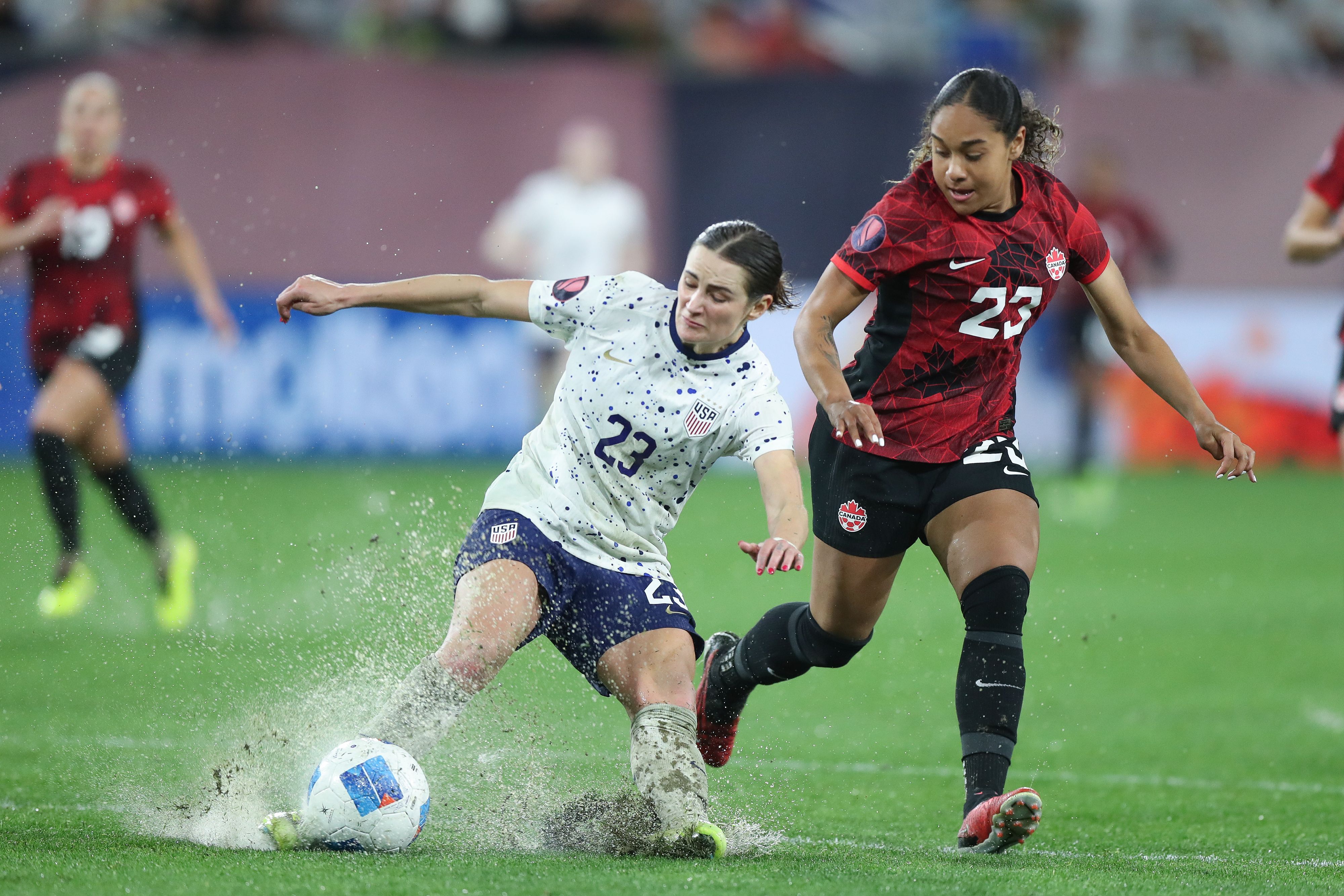 Emily Fox #23 of the United States is marked by Olivia Smith #23 of Canada during the Semifinals - 2024 Concacaf W Gold Cup match between Canada and United States at Snapdragon Stadium on March 6, 2024 in San Diego, California. (Photo by Omar Vega/Getty Images)