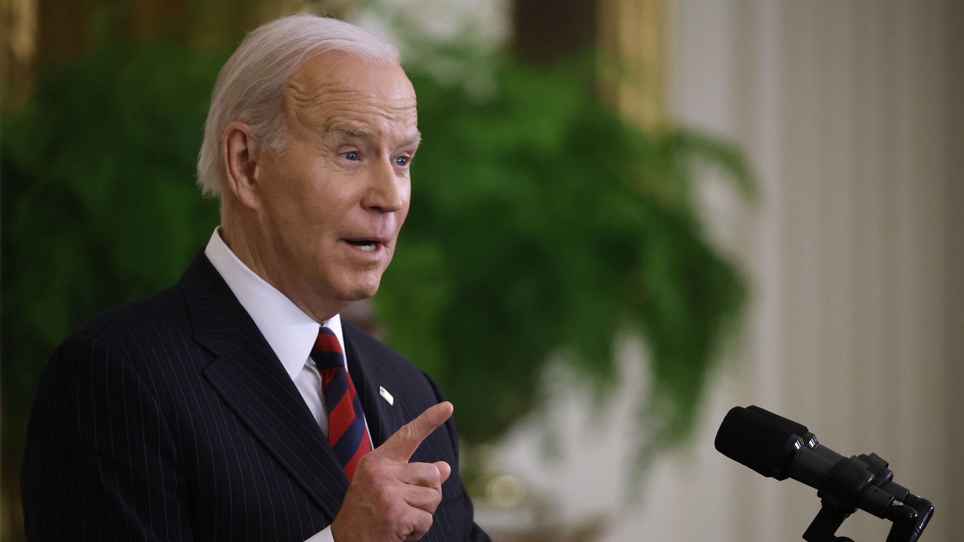 Picture of Biden speaking behind a microphone