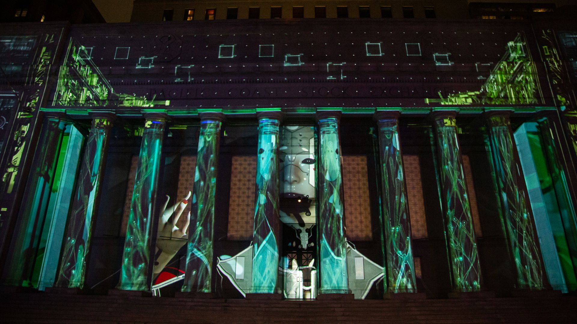 Photo of a large art piece projected onto a building