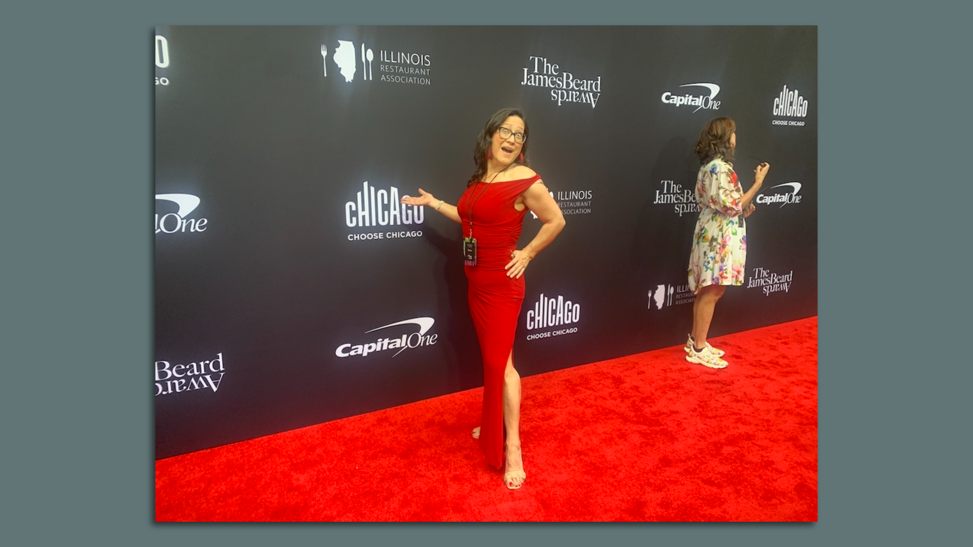 Axios Chicago reporter poses in a red gown on the red carpet.