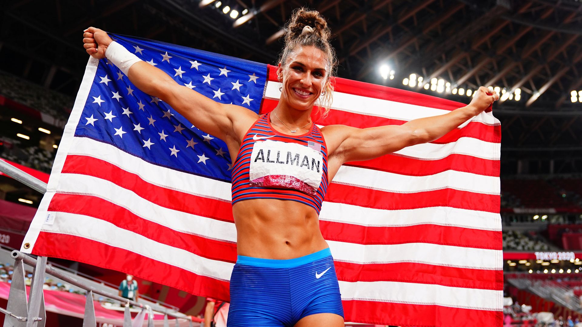 Valarie Allman of Team USA holding up an American flag behind her