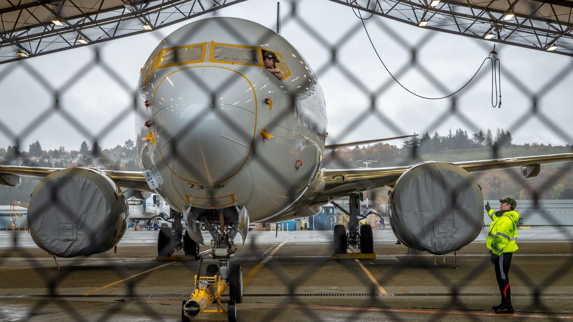 Workers inspect a Boeing 737 MAX aircraft.