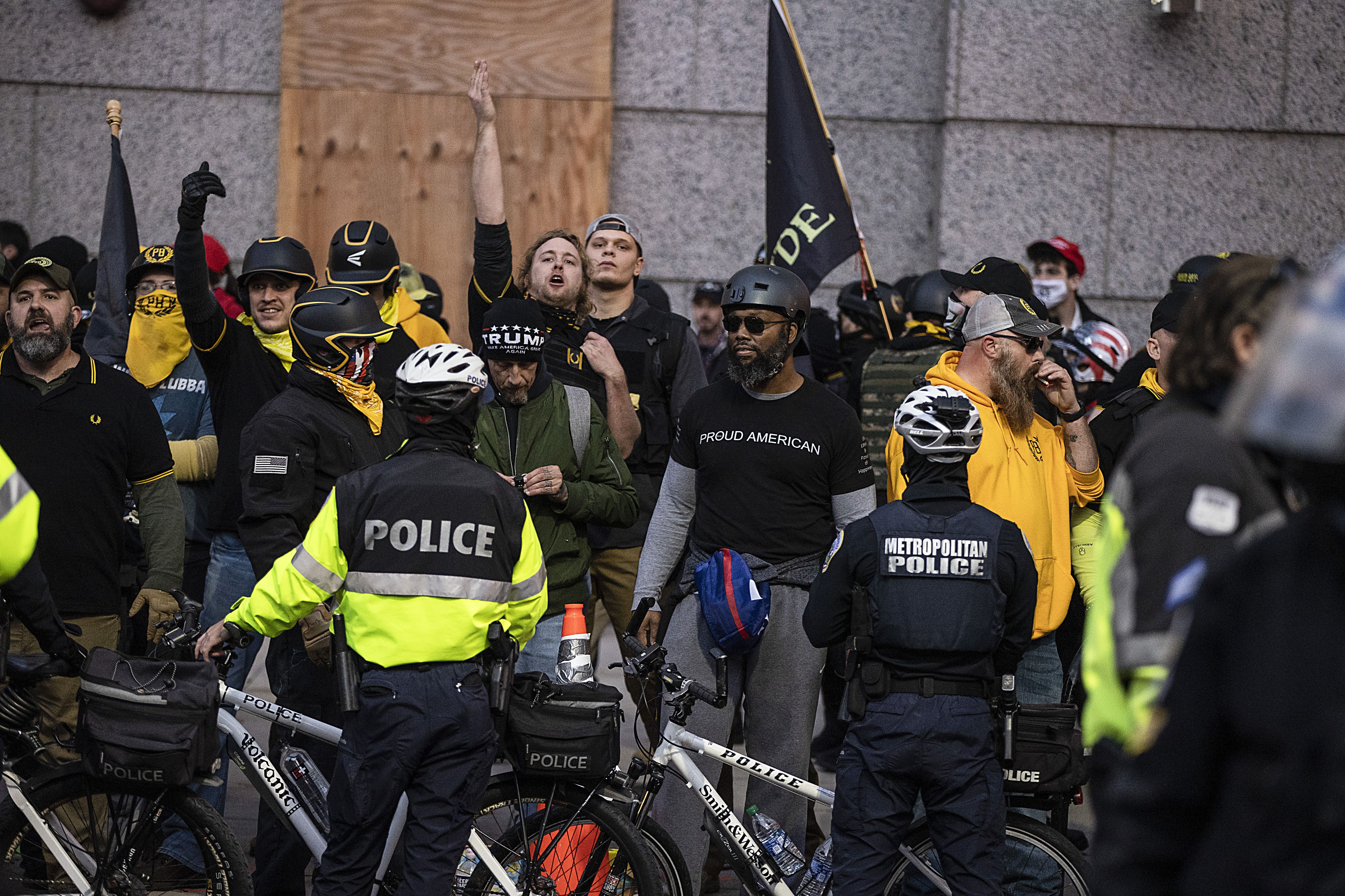  Members of the Proud Boys and counter-protesters stand off near Black Lives Matter Plaza on December 12, 2020 in Washington, DC. 
