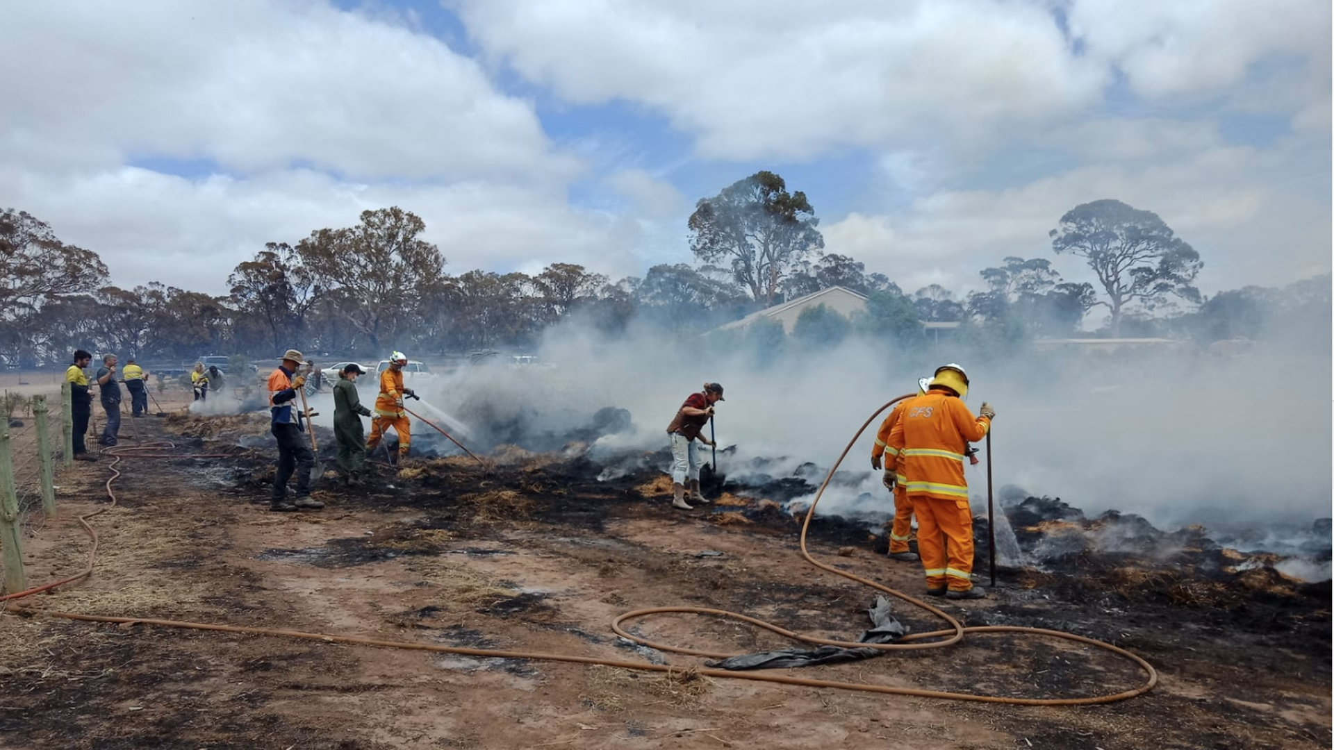 Firefighters in the Adelaide Hills, in the state of South Australia, working with locals to extinguishi a hay bales blaze and assisting with fire protection efforts