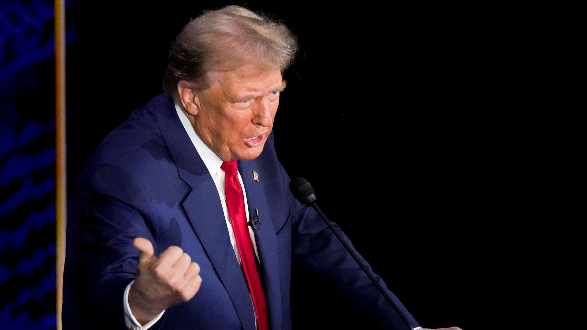 Former president Donald Trump stands at a podium during Tuesday's debate