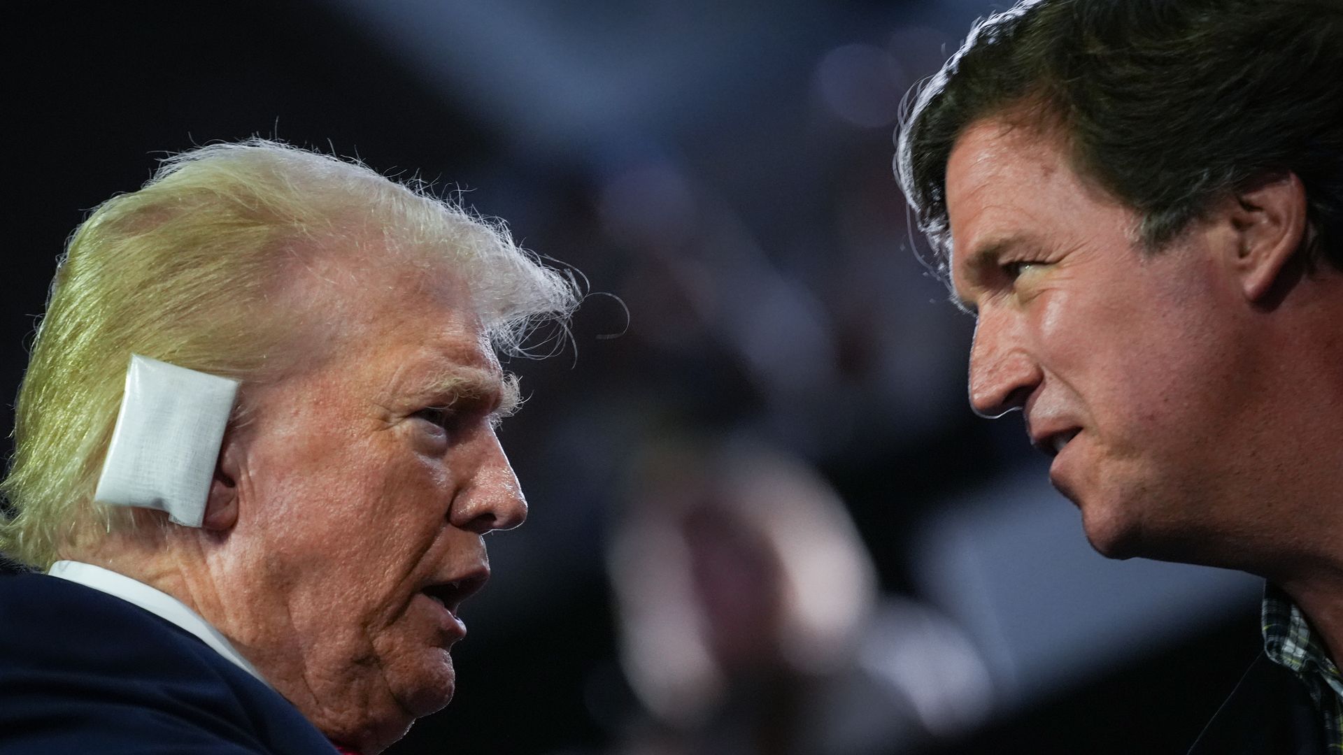  Republican presidential candidate, former U.S. President Donald Trump greets Tucker Carlson on the first day of the Republican National Convention at the Fiserv Forum on July 15, 2024 in Milwaukee, Wisconsin
