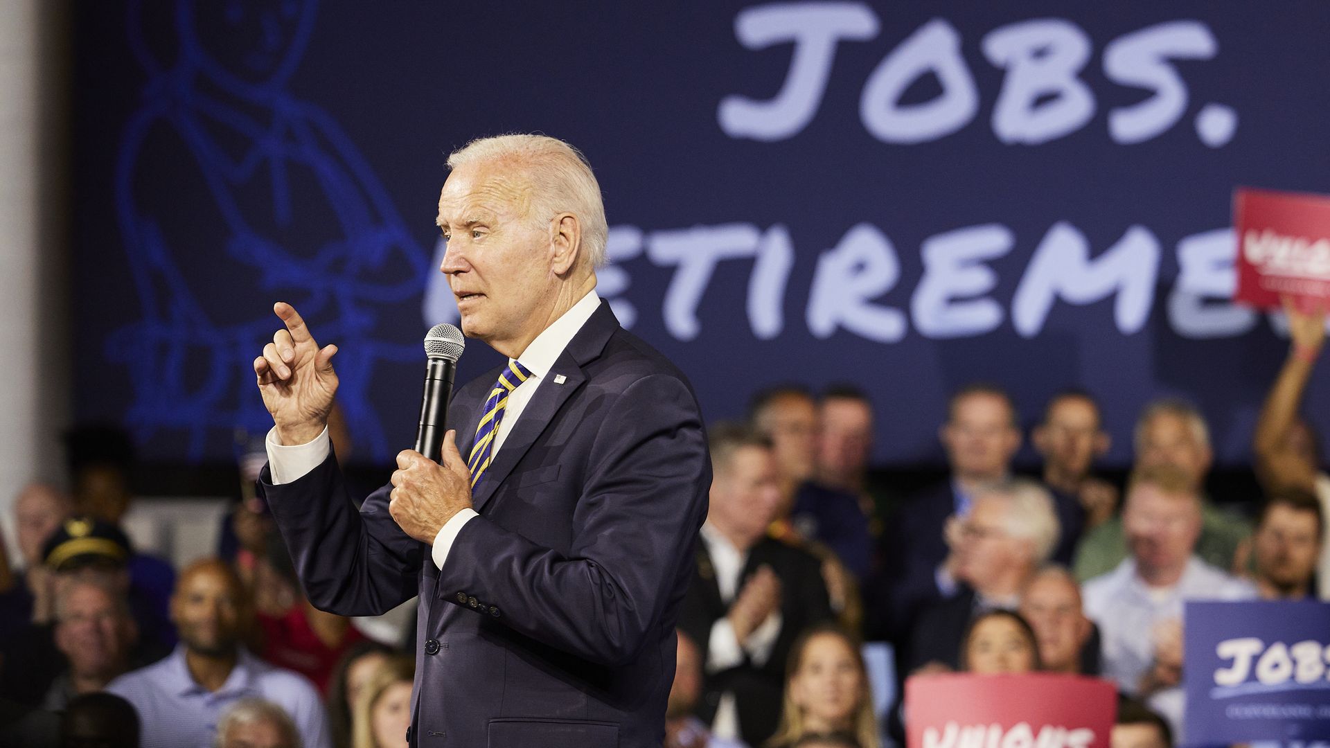 Biden wags his finger in front of a sign