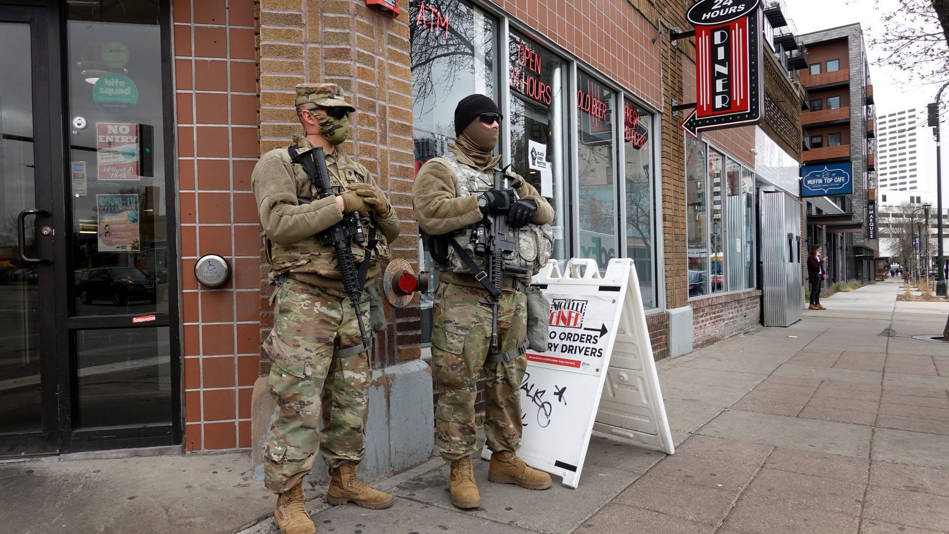 National guard members stand outside a building