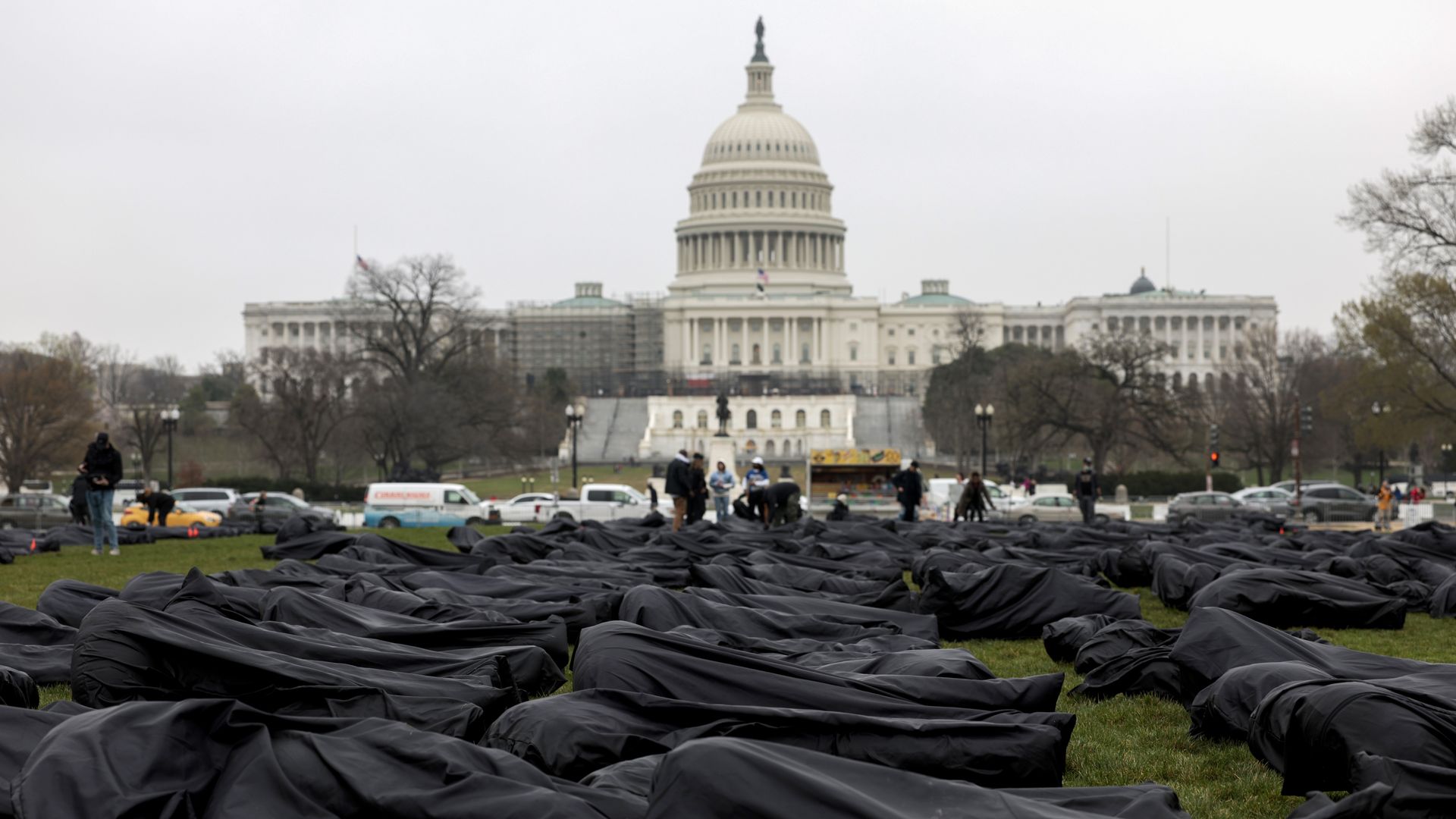 Symbolic black body bags are seen spread on the National Mall and against a backdrop of the Capitol.