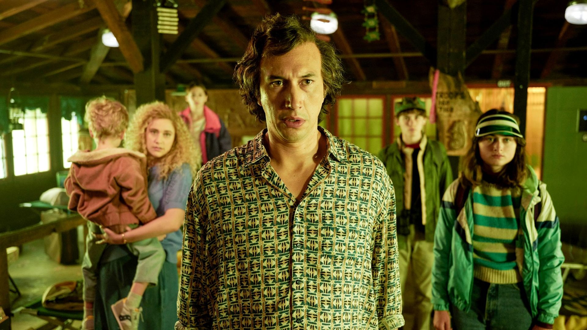 Actor Adam Driver stands front and center surrounded by his fictional family in the movie "White Noise." 
