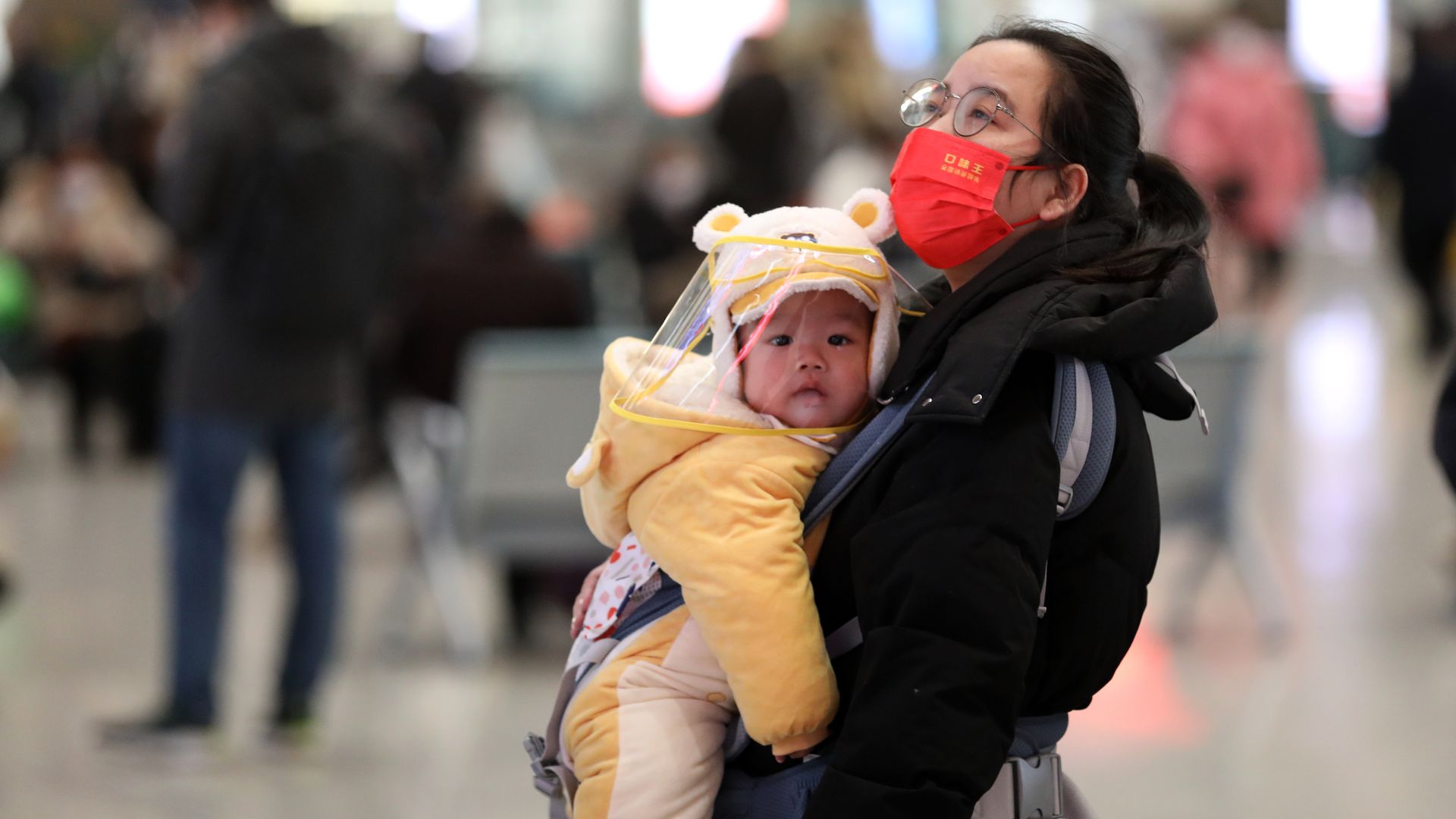 A woman holds a baby at Shijiazhuang Railway Station on the first day of 2023 China's Spring Festival travel rush on January 7, 2023 in Shijiazhuang, Hebei Province of China. 