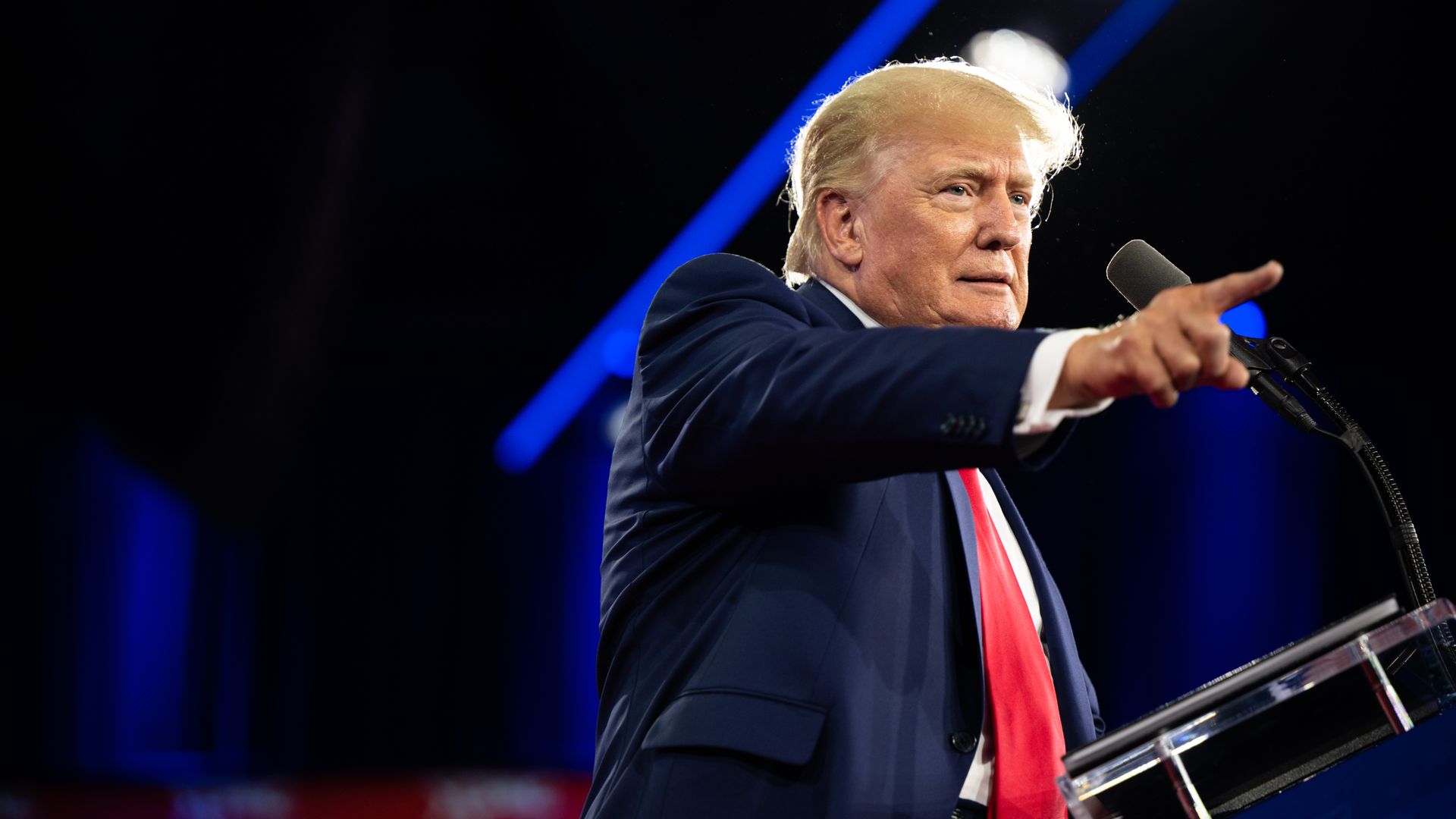 Photo of Donald Trump speaking from a podium and raising his right finger
