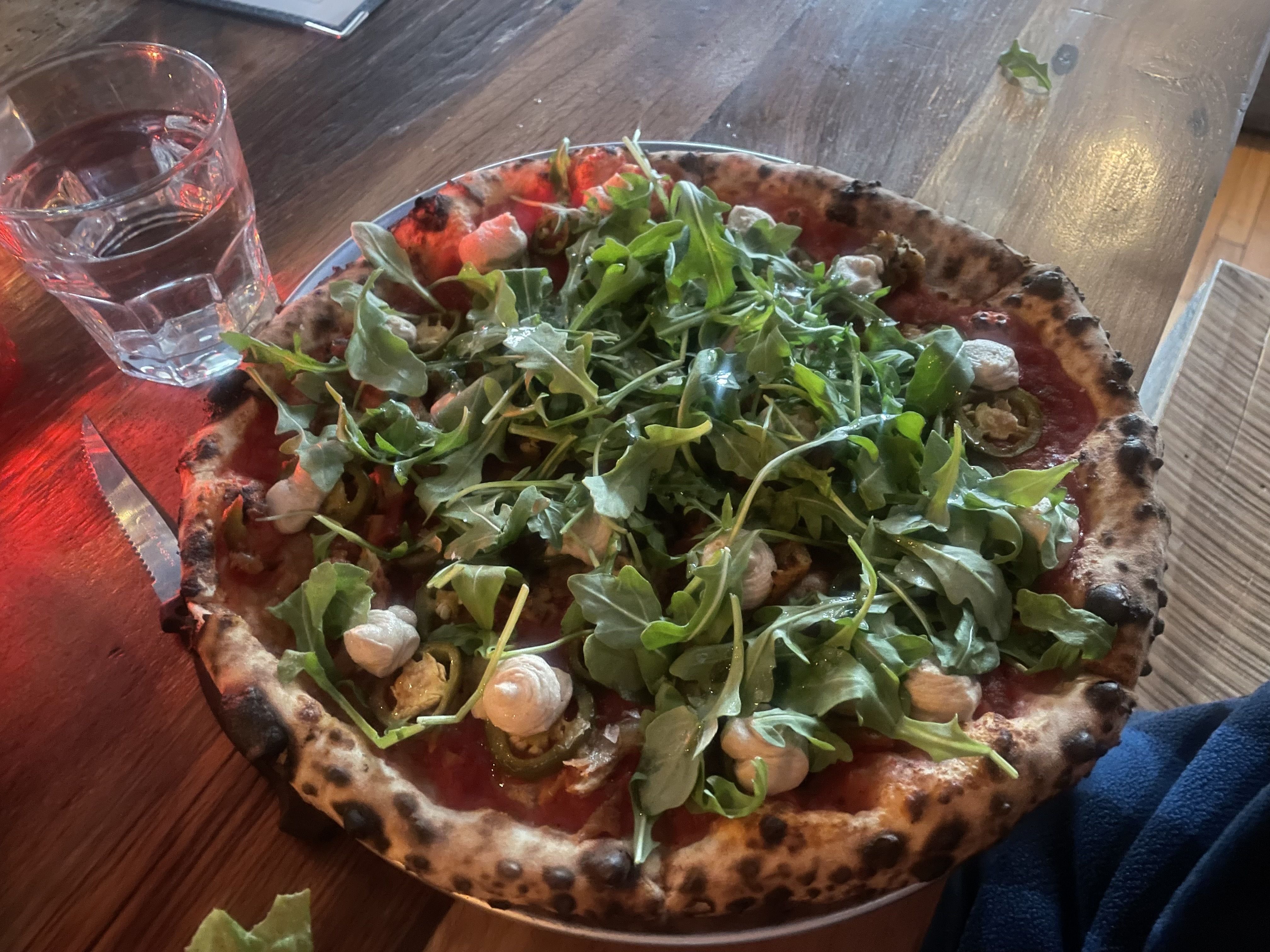 pizza with arugula on top