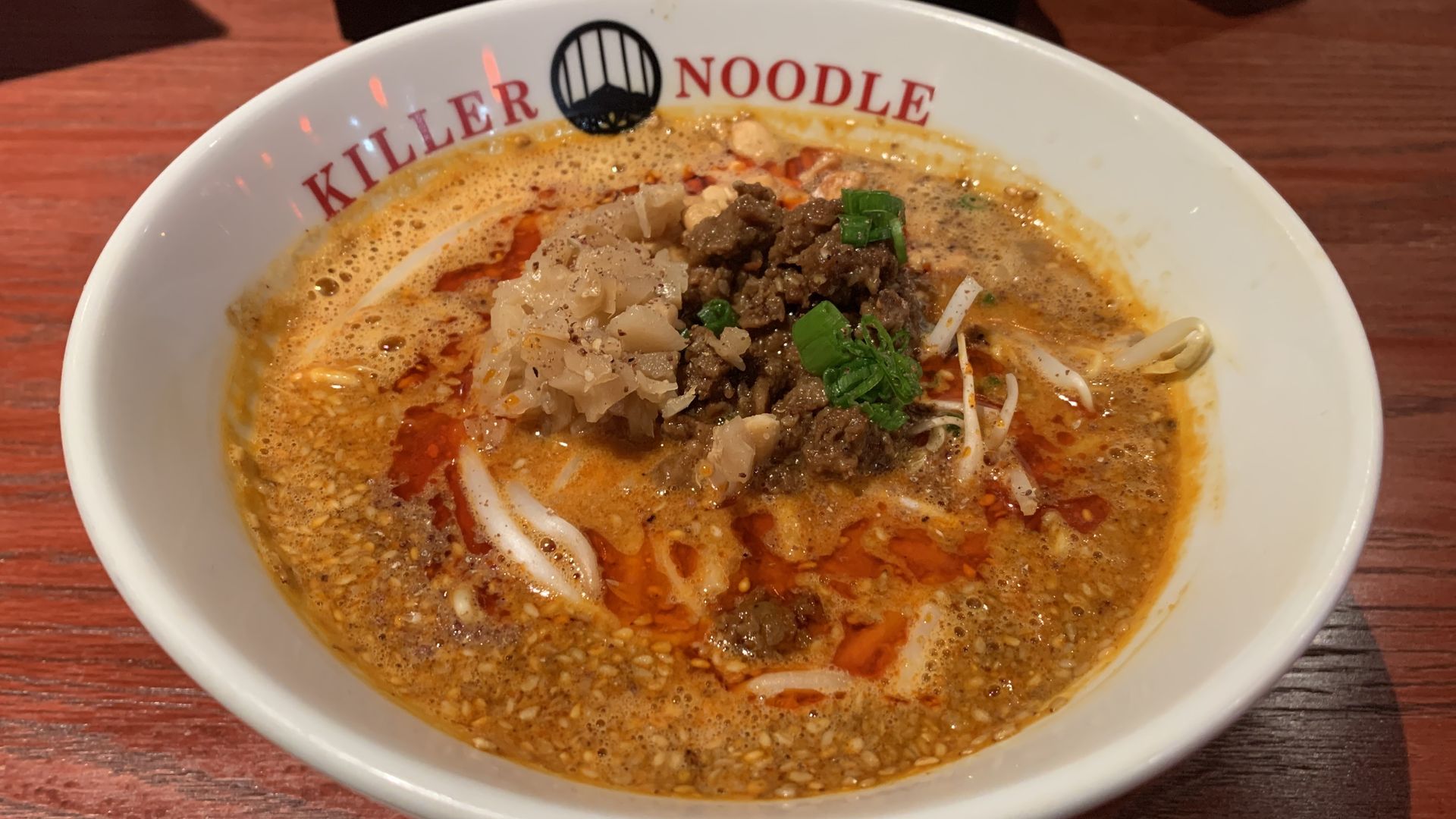 Photo of a bowl with the words "Killer Noodle" and ramen inside the bowl. 