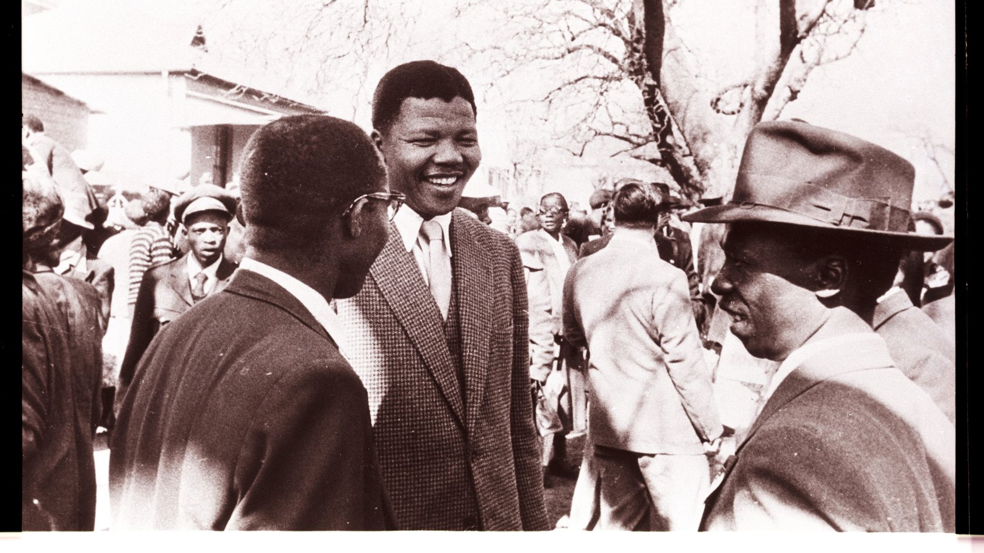 Nelson Mandela speaking with codefendants outside the "Treason Trial" late 1950's in South Africa.