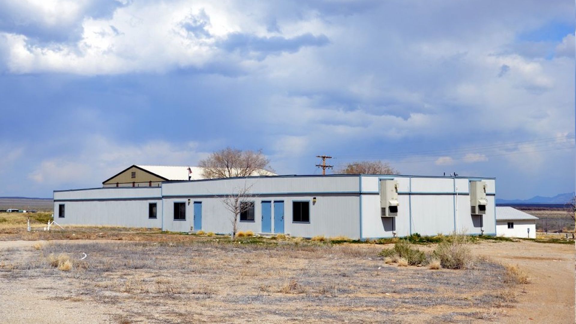A white building in the desert. 