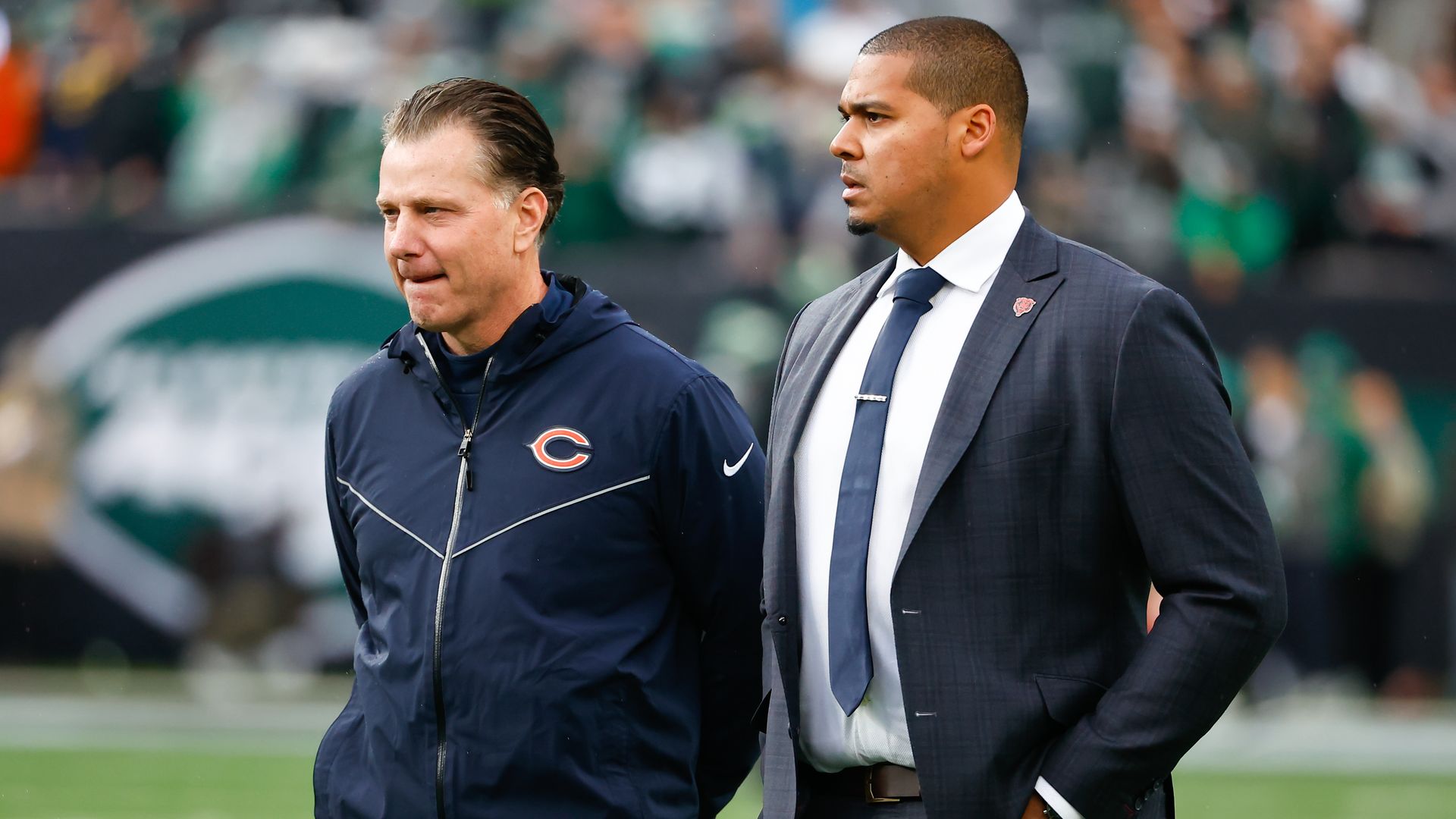 Photo of two men on a football field. 