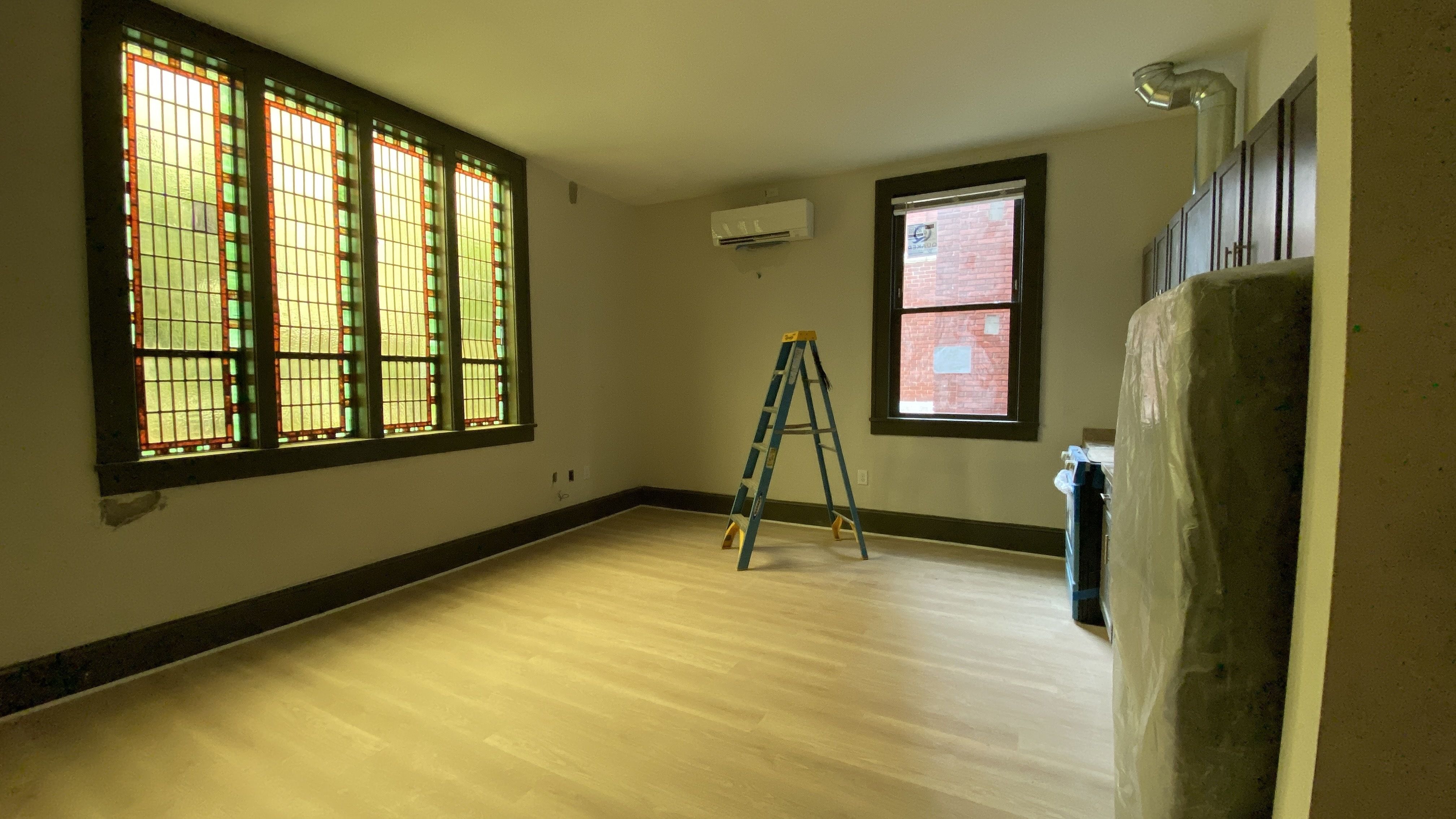 Easter's Home unit with stained glass on the left and a kitchenette on the right. 