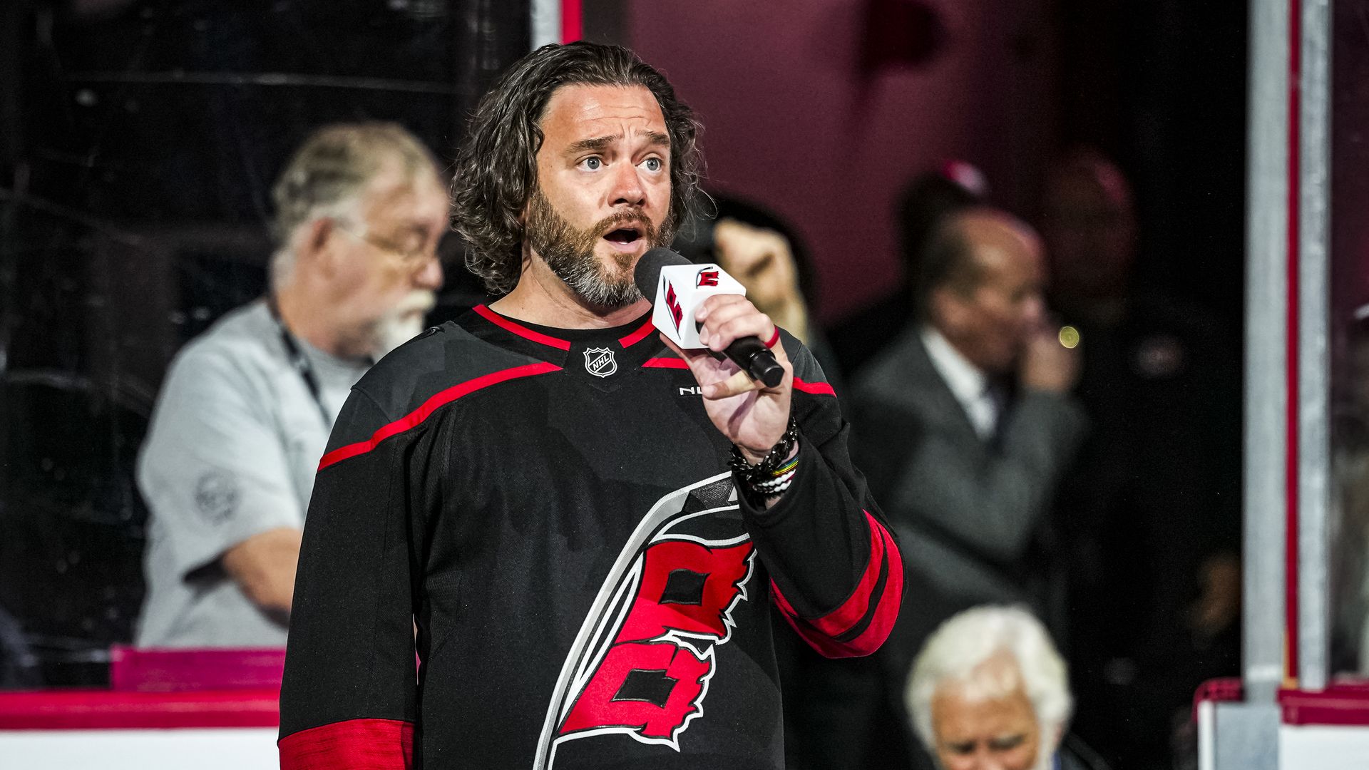 Adam Lee Decker, wearing a Carolina Hurricanes jersey, sings the national anthem in Raleigh for Game One of the First Round of the 2026 Stanley Cup Playoffs.