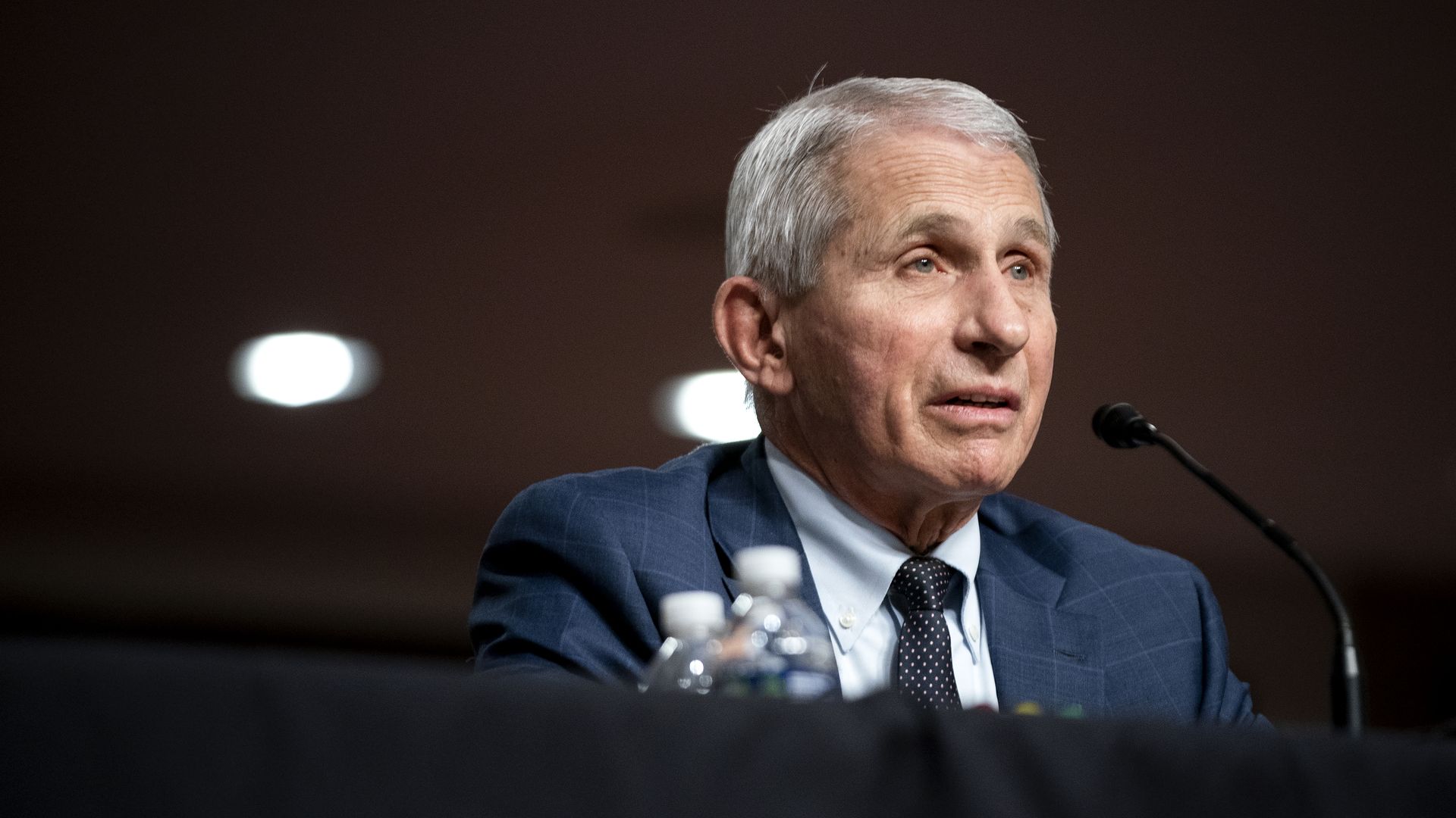 Photo of Anthony Fauci speaking into a mic