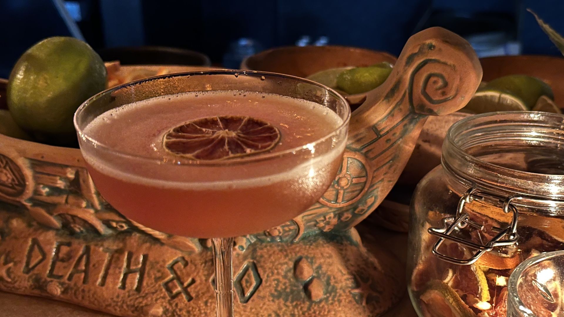 A photo of a cocktail and a candle