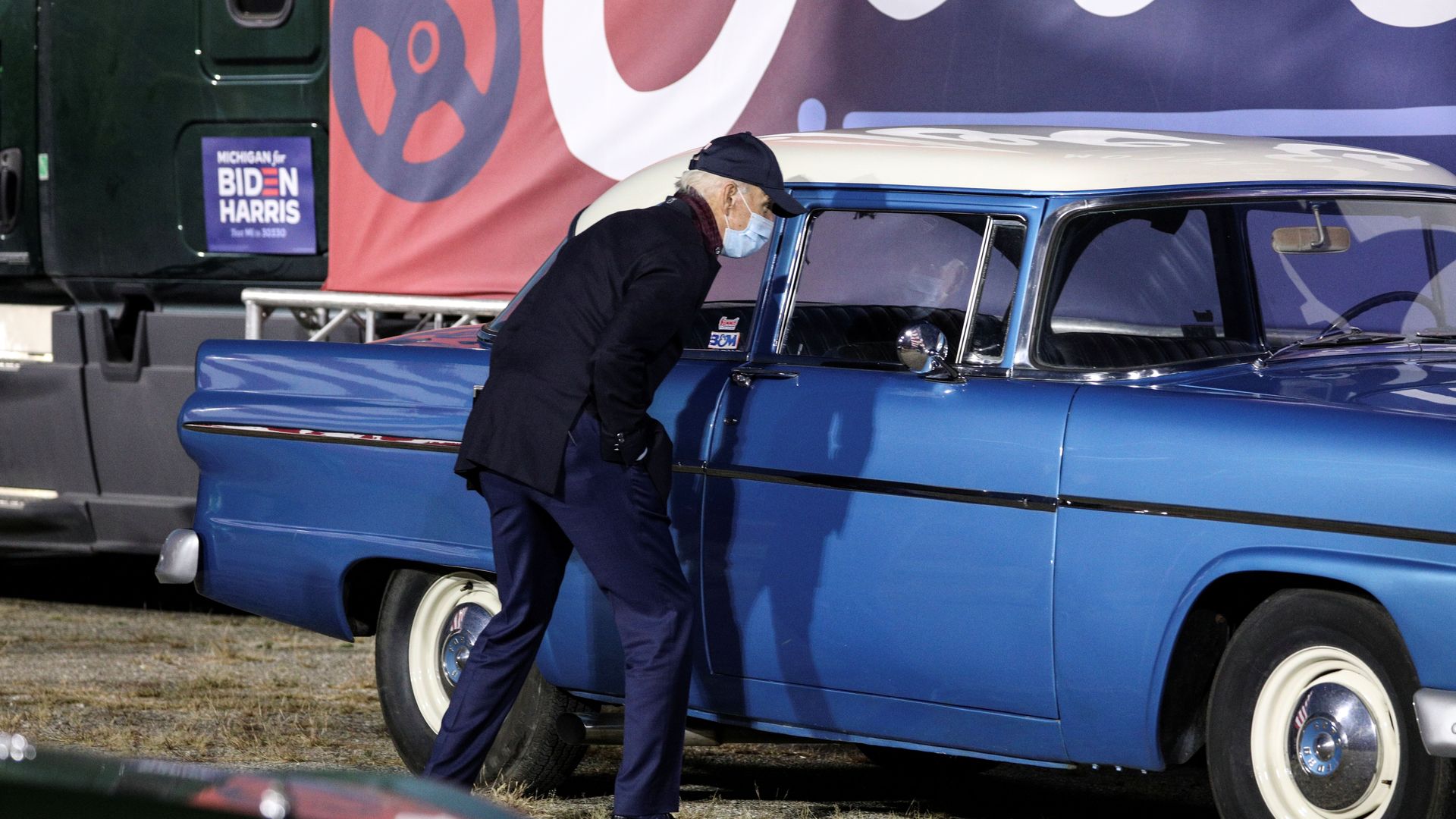 Joe Biden checks out a classic car at the end of a voter mobilization event at the Michigan State Fairgrounds in Novi, Mich., yesterday.