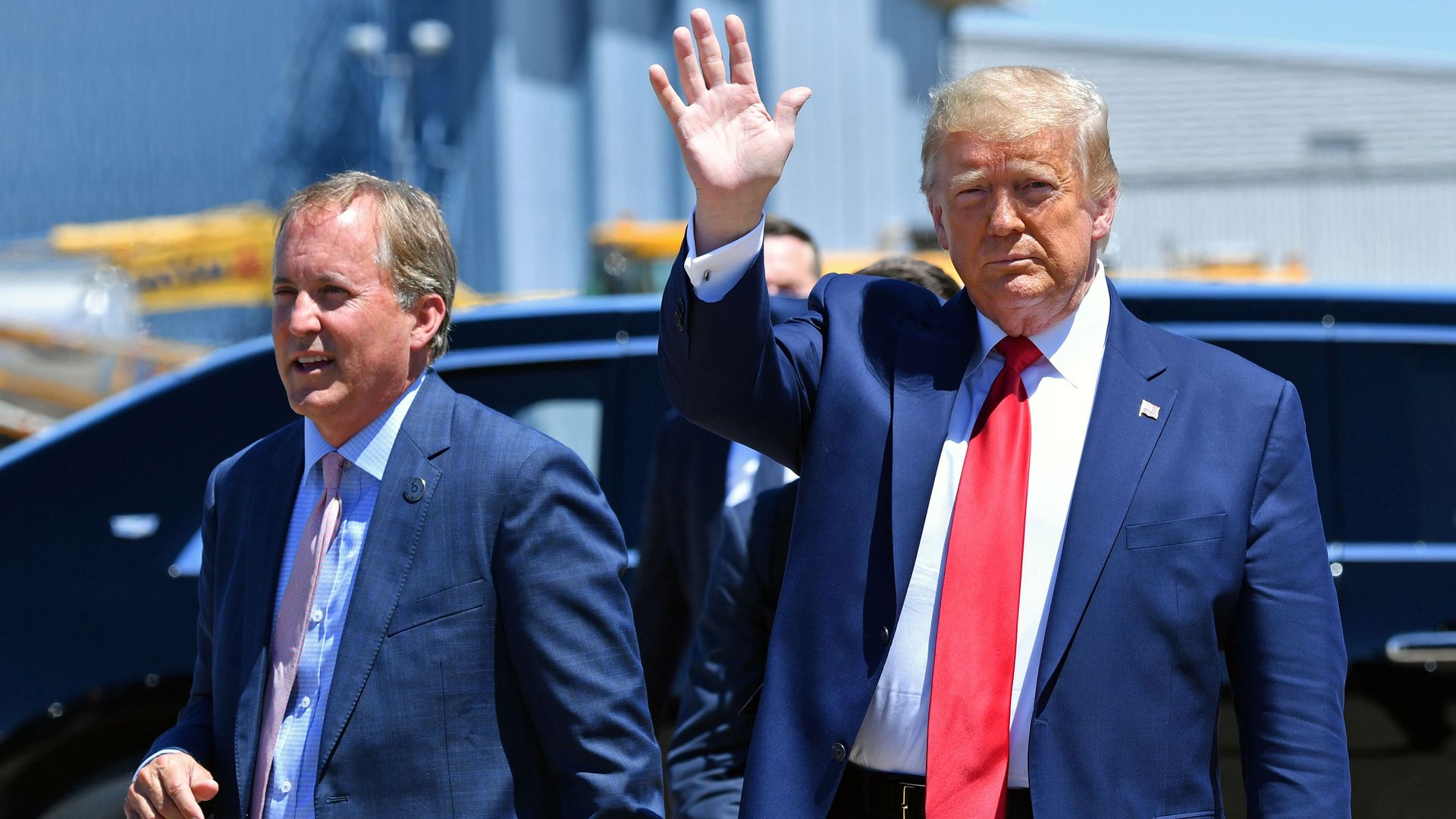  President Trump waves upon arrival, alongside Attorney General of Texas Ken Paxton (L) in Dallas, Texas, on June 11, 2020