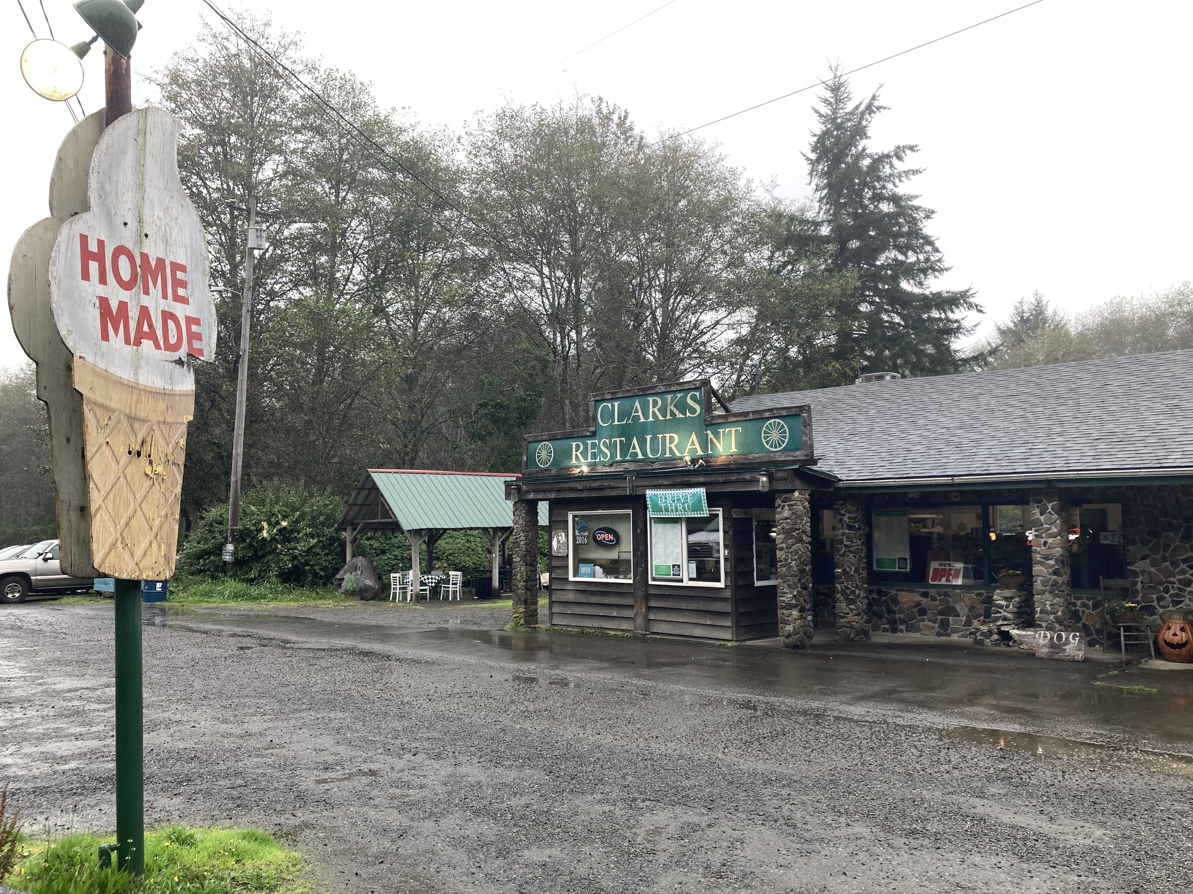 A brown restaurant with green trim and an ice cream cone sign. 