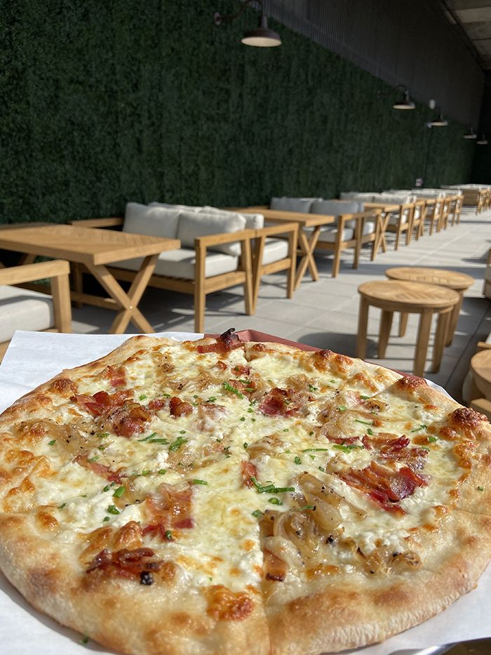 Sycamore's tart flambé pizza ($16) in the upstairs biergarten. Photo: Ashley Mahoney/Axios