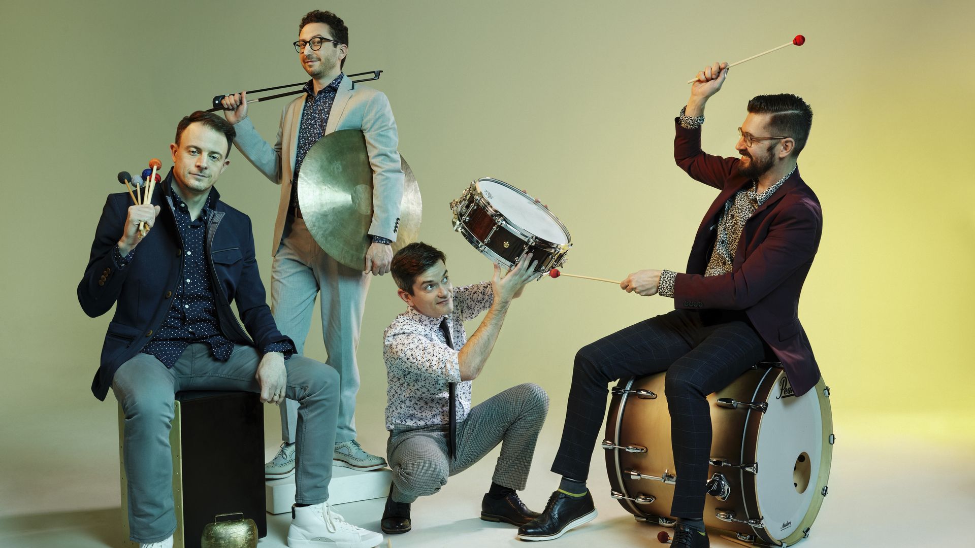 Photo of a band holding various percussion instruments. 