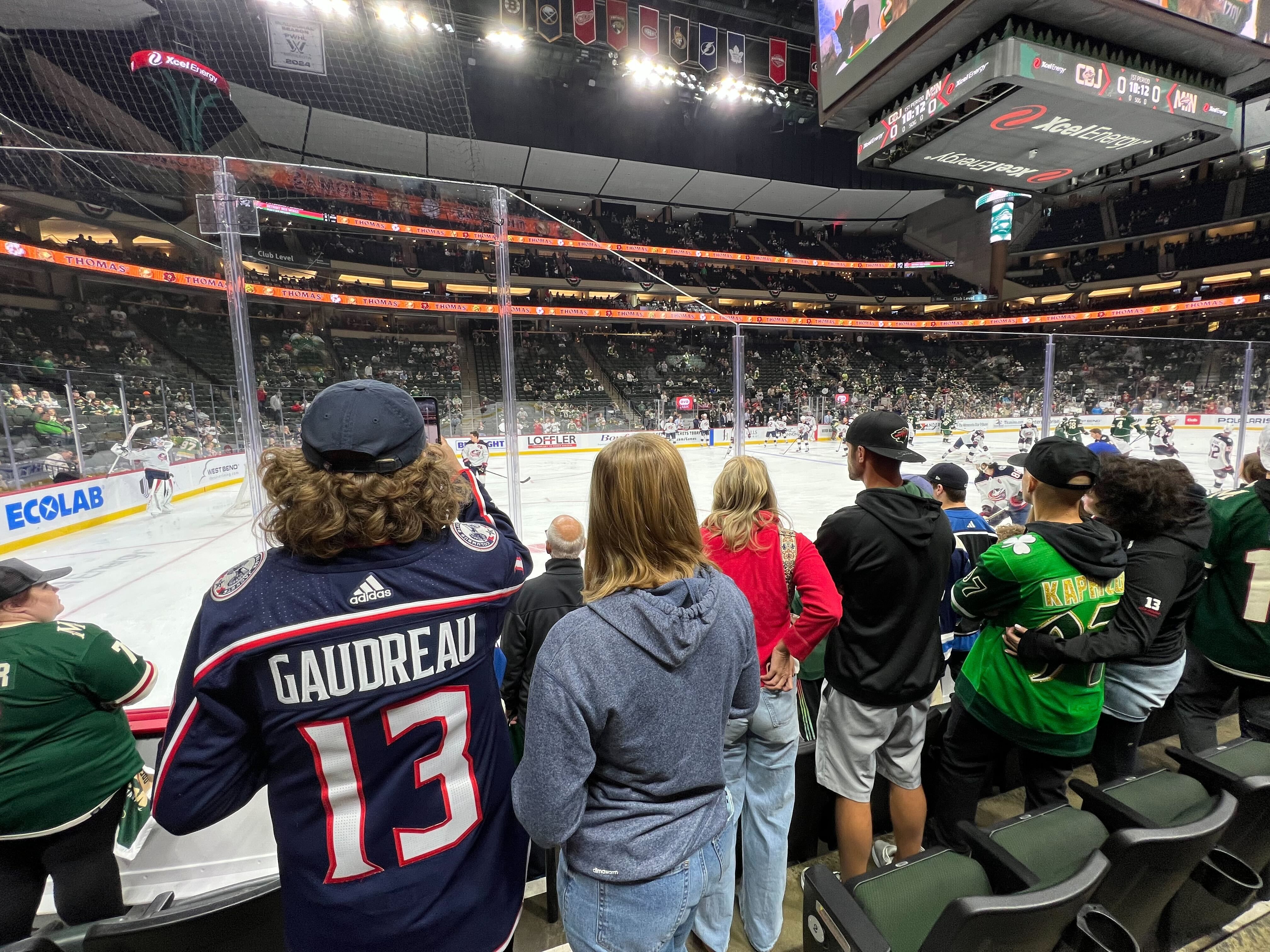 Fans watch a pregame hockey warm up. 