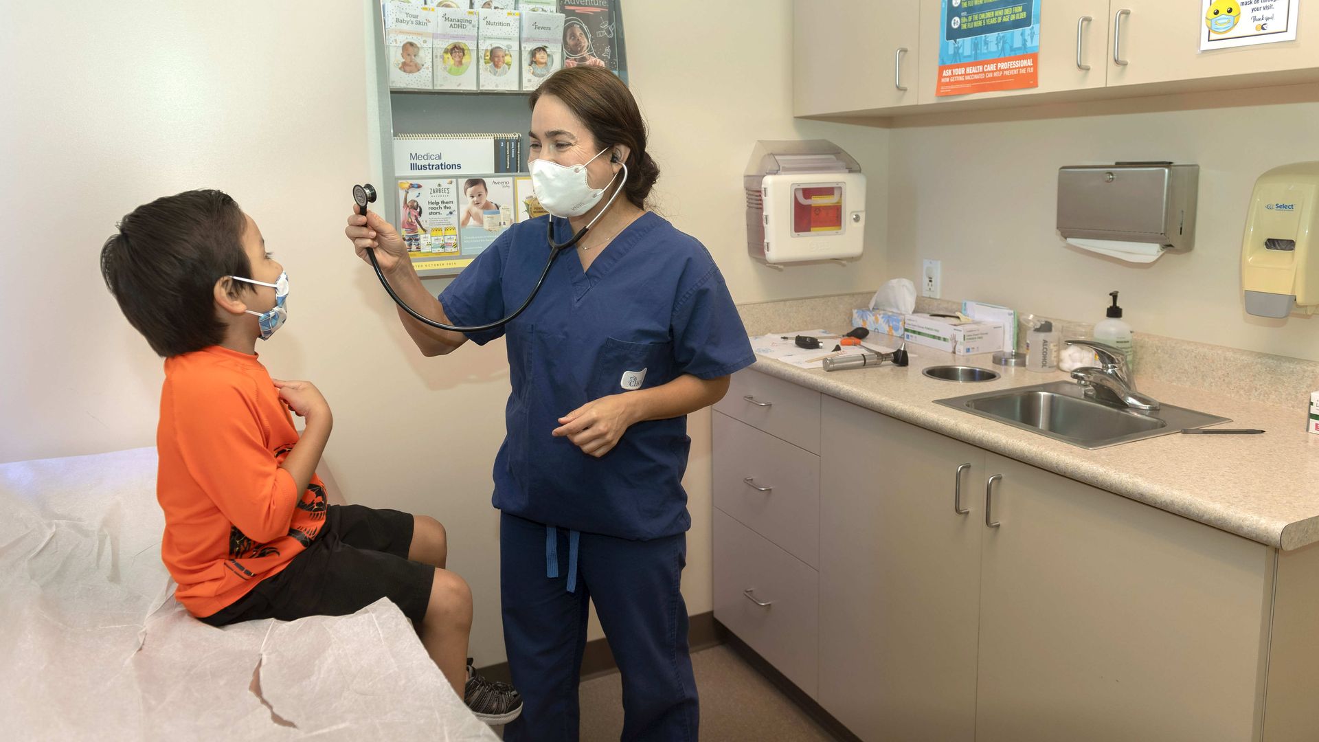 : Dr. Kate Williamson examines a child during a yearly routine exam at Southern Orange County Pediatric Associates in Ladera Ranch, CA on Tuesday, July 28, 2020