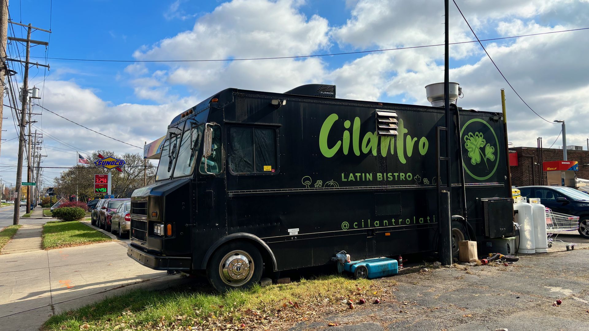 A black food truck that says "Cilanto Latin Bistro" on the side in green lettering