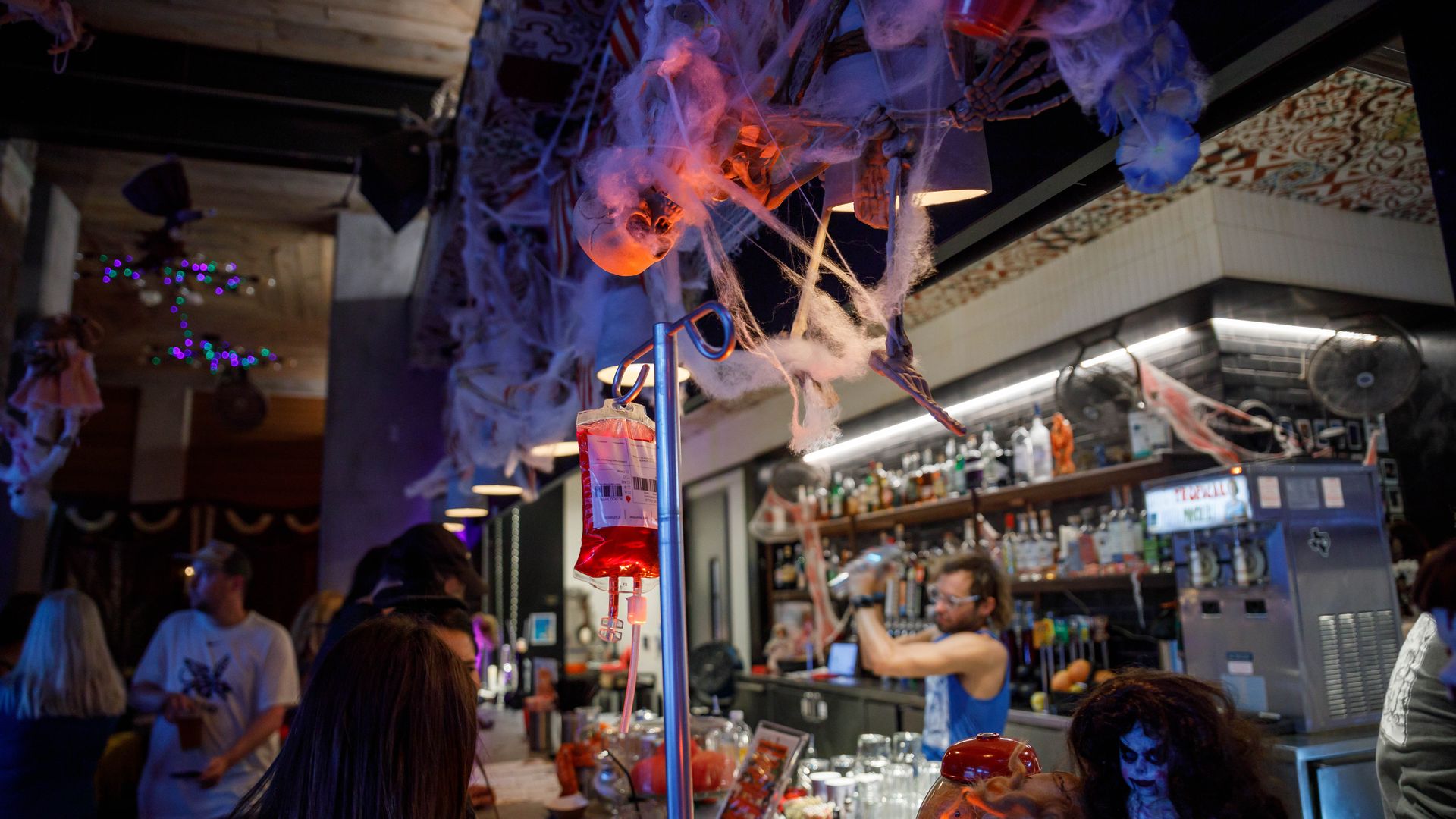 A photo of a bar surrounded by Halloween decorations.