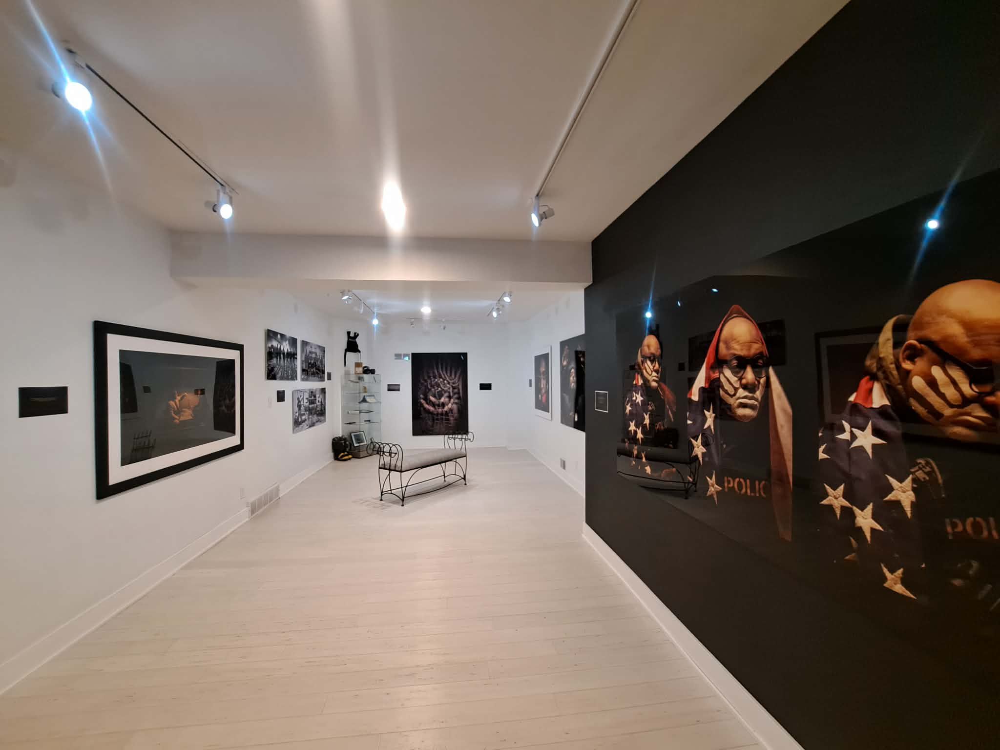 A range of photos down a hallway as part of the exhibition.