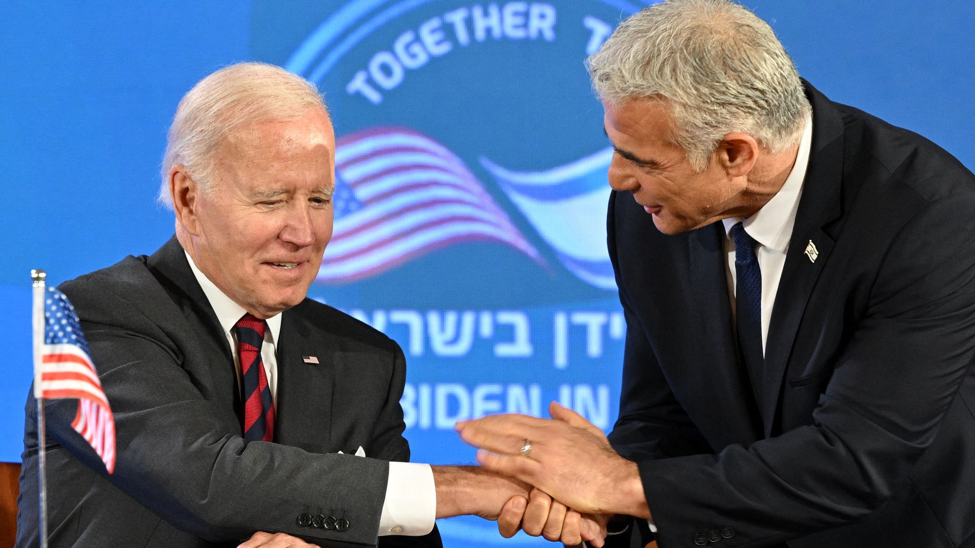 President Biden shakes hands with Israeli Prime Minister Yair Lapid. 