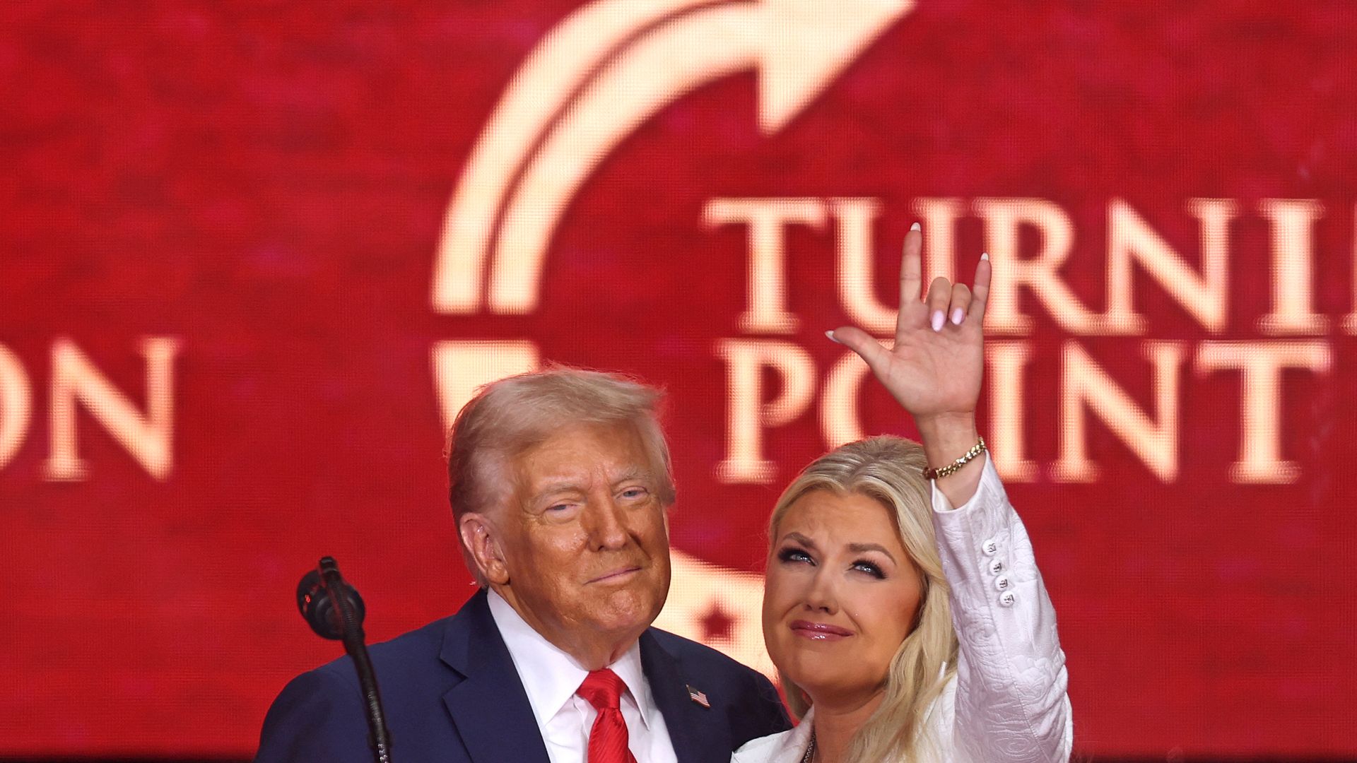 President Trump and Erika Kirk in front of a red background that says "Turning Point."
