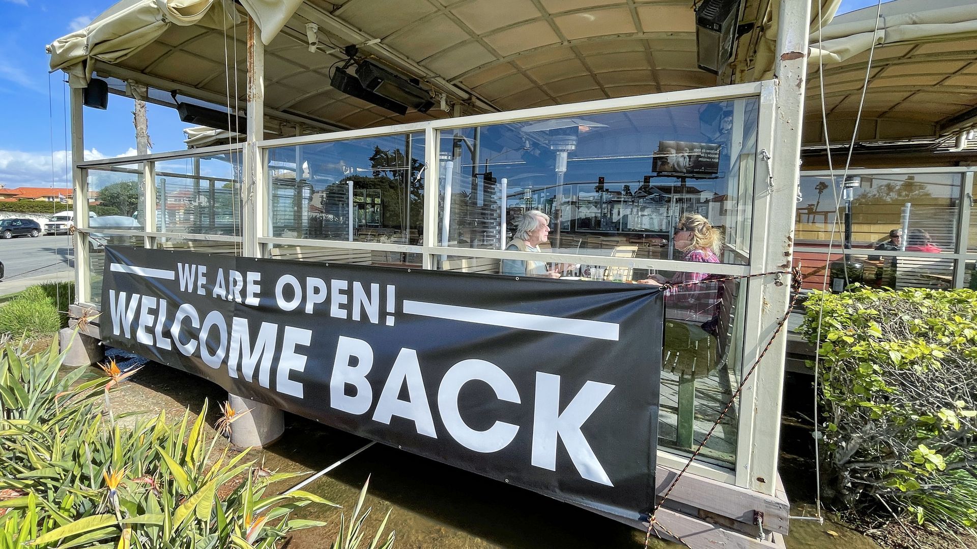 Diners eat on the patio at Fish Camp in Huntington Beach, California. 