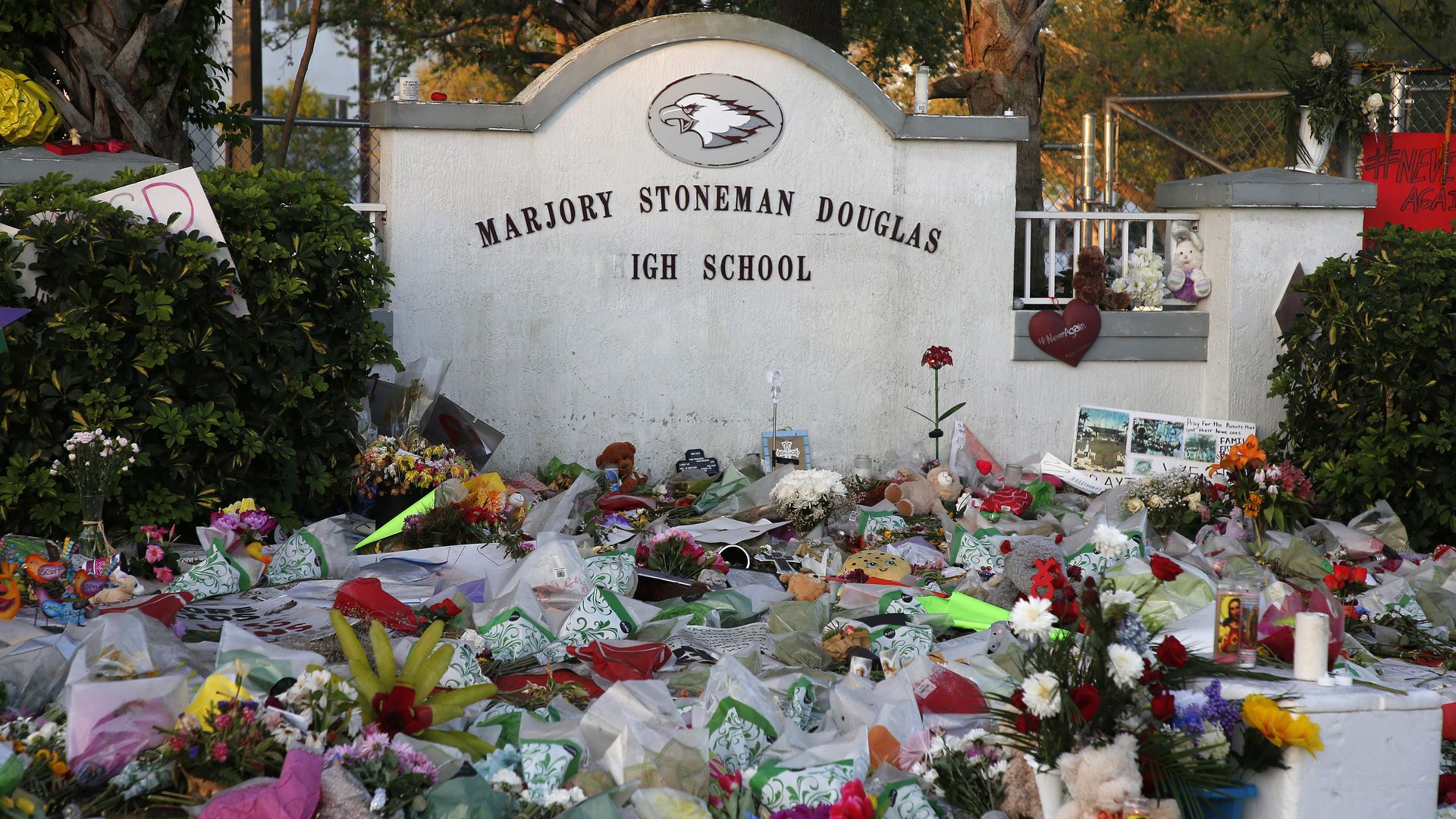 Flowers, candles and mementos sit outside one of the makeshift memorials at Marjory Stoneman Douglas High School in Parkland, Florida on February 27, 2018. 