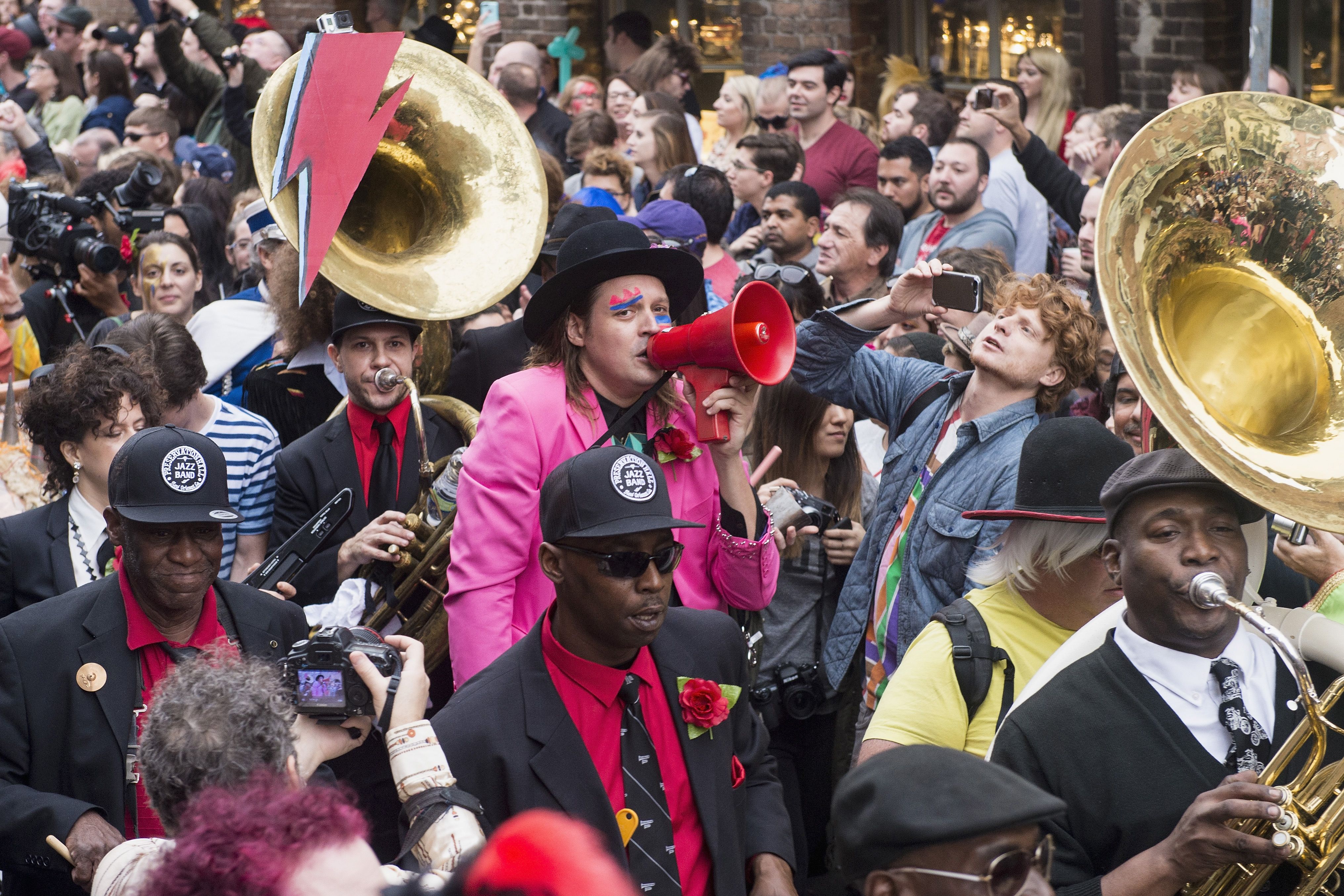 Win Butler of Arcade Fire and Preservation Hall Jazz Band lead a second line parade in honor of David Bowie.