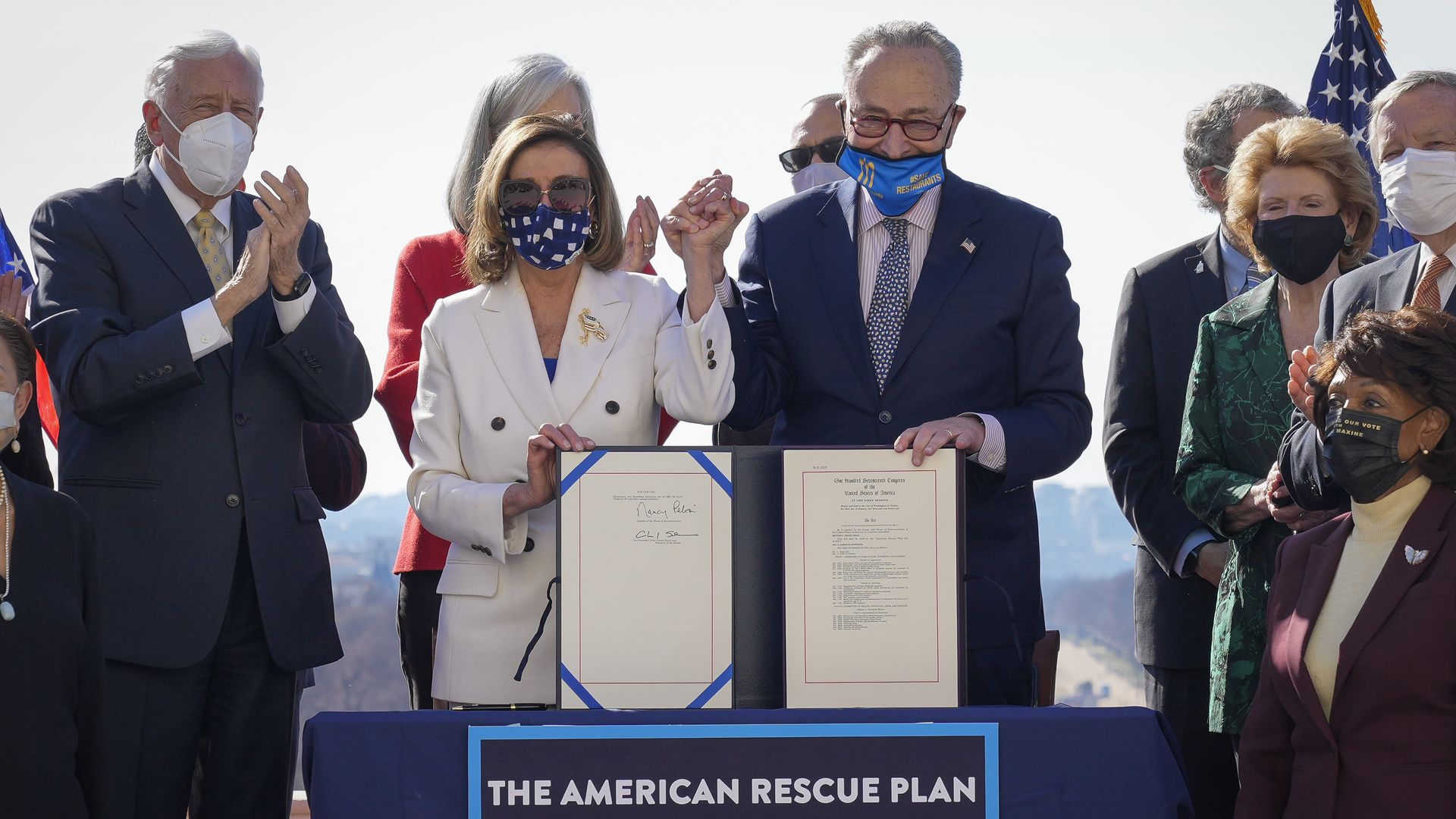 House Speaker Nancy Pelosi and Senate Majority Leader Chuck Schumer are seen celebrating after passing the COVID-19 relief law.