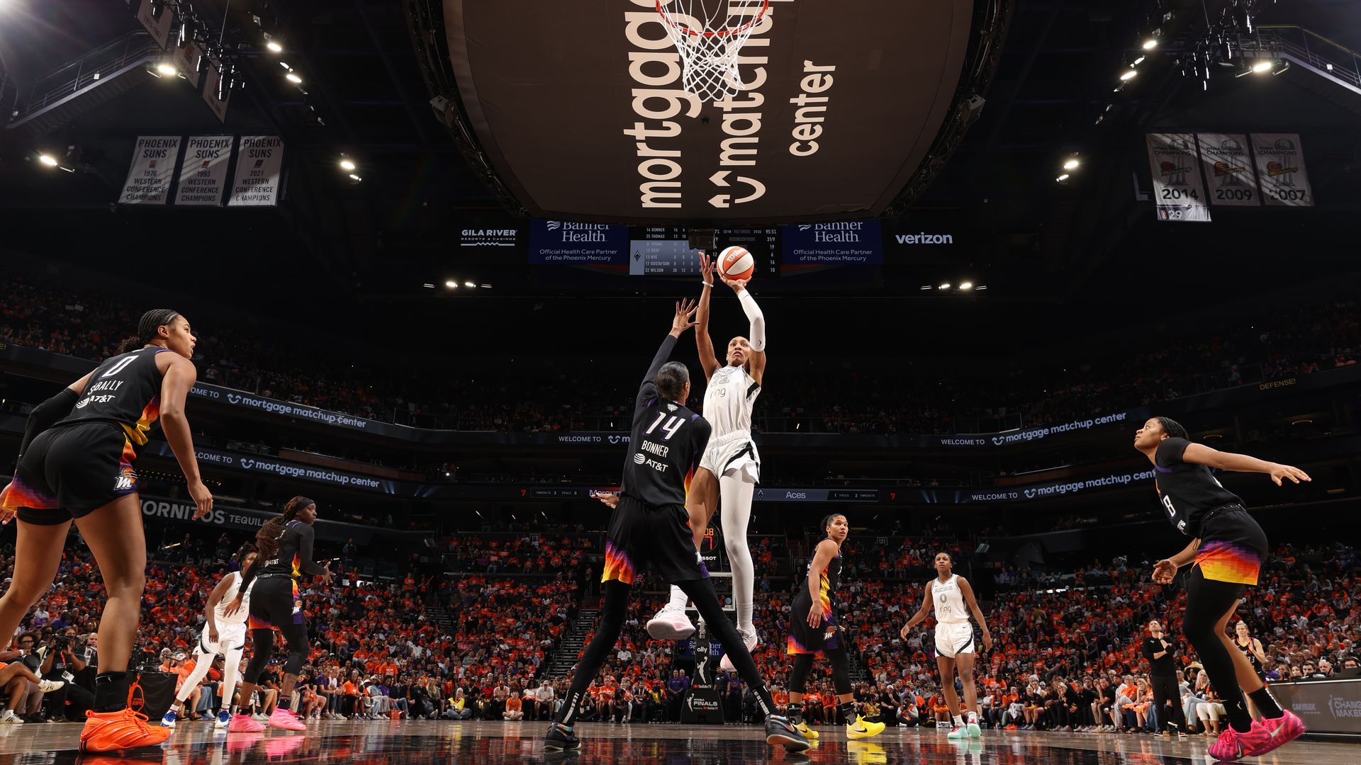 A Las Vegas Aces player shoots above a Phoenix Mercury player in the Mortgage Matchup Center.