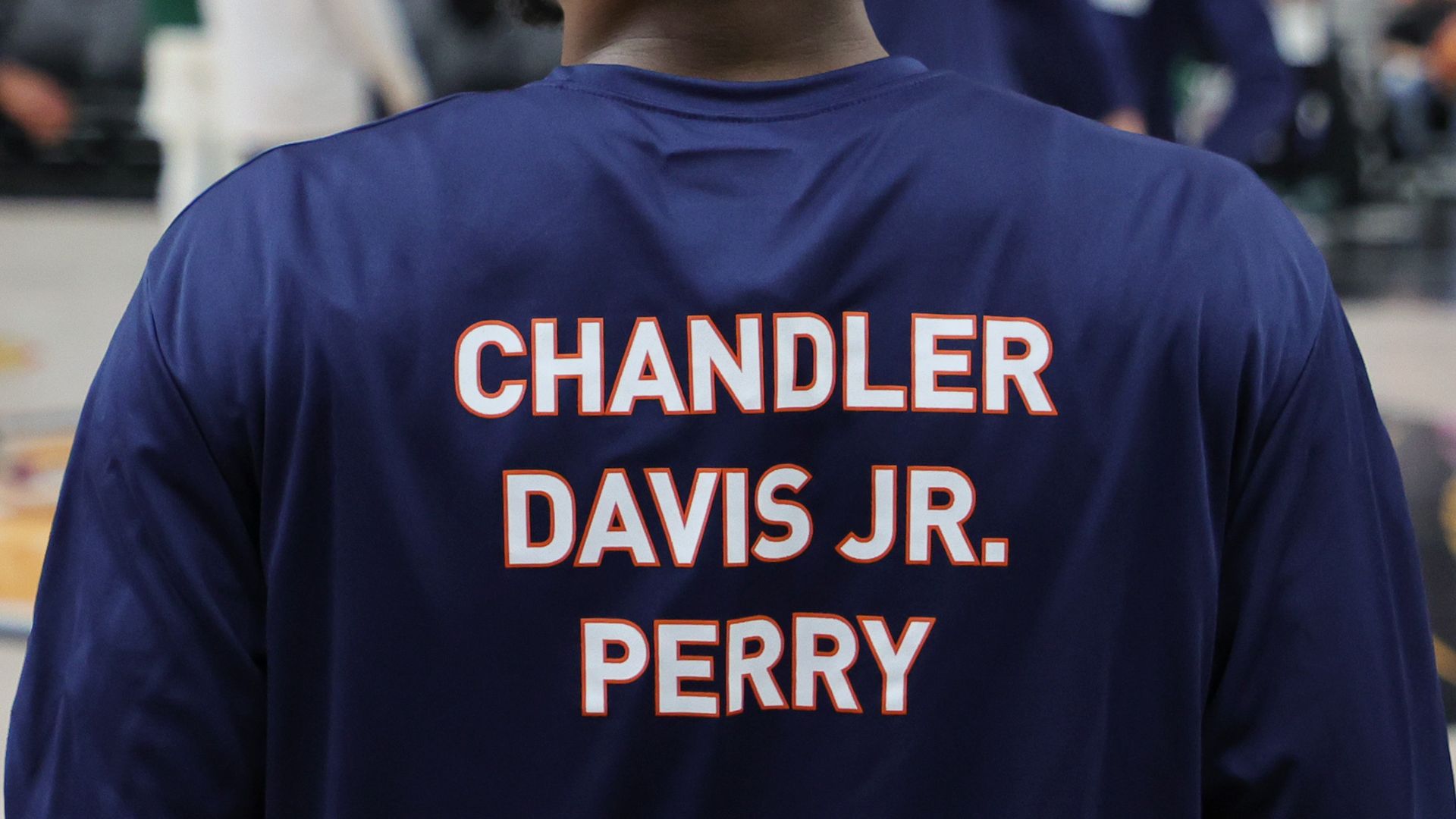 Chase Coleman #12 of the Virginia Cavaliers wears a warmup shirt in honor of three Virginia football players.