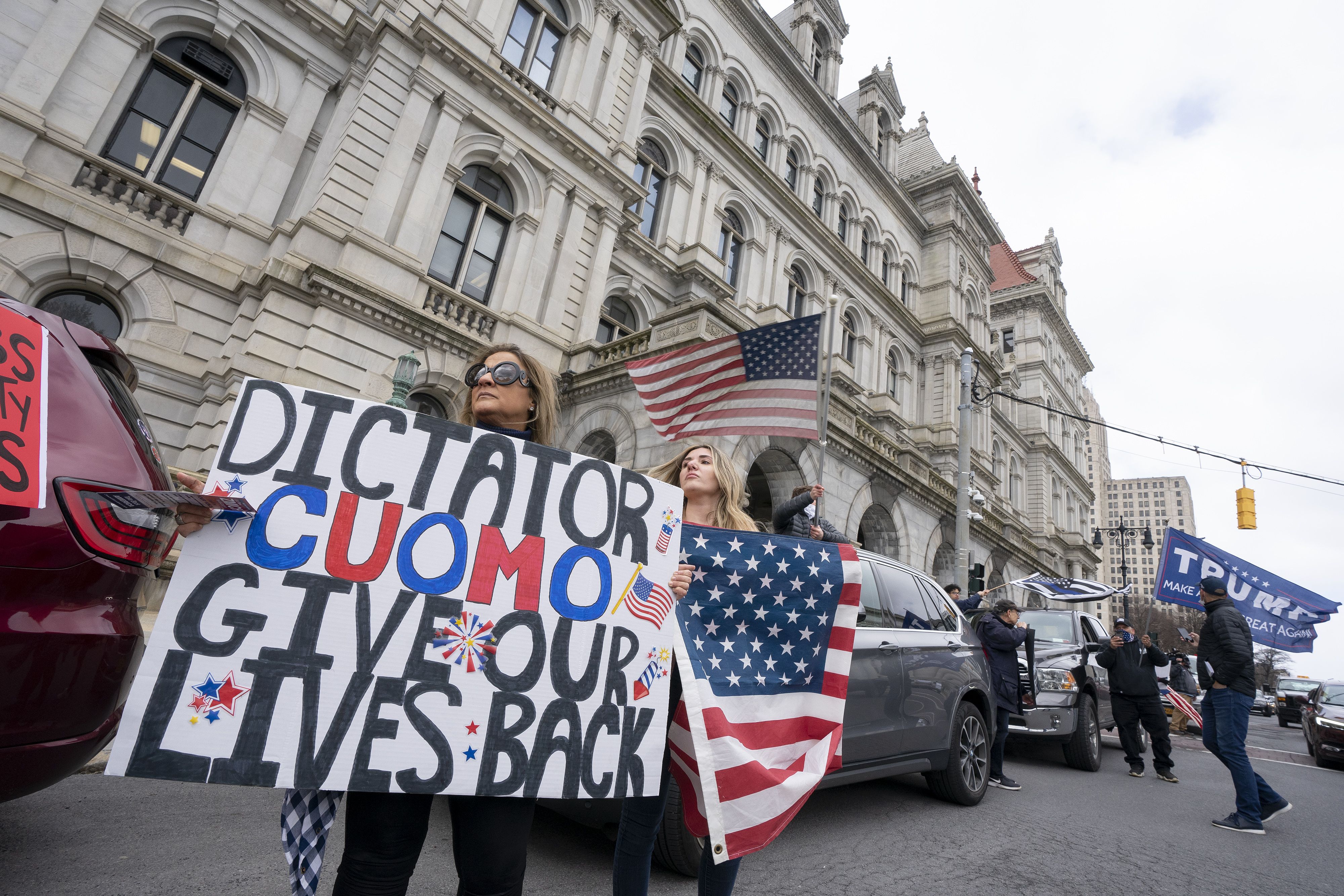 Demonstrators hold signs outside of the New York State Capitol Building on April 22, 2020 in Albany, New York