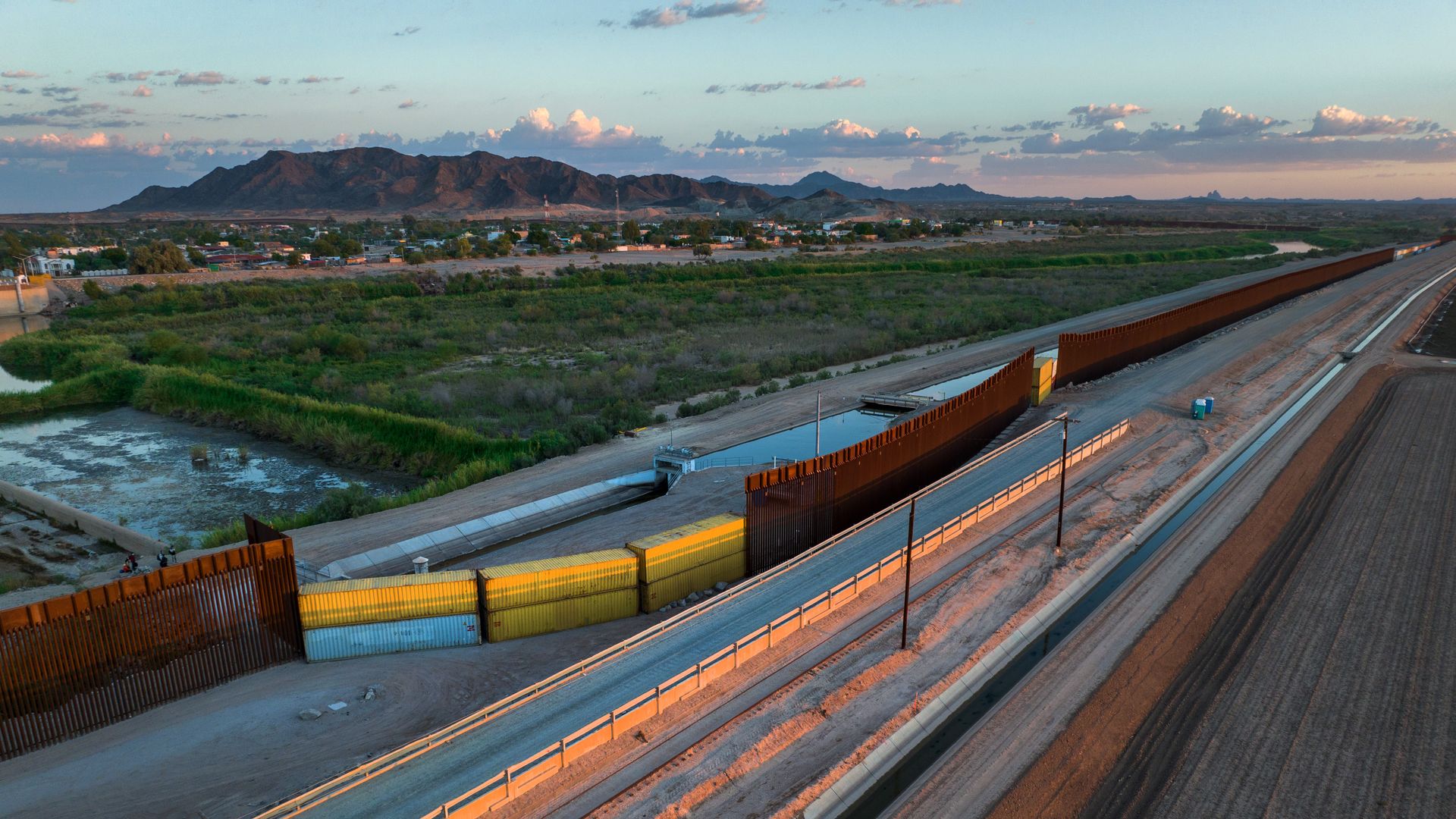 n this aerial view, shipping containers fill a previous gap in the U.S.-Mexico border wall on September 27, 2022 in Yuma, Arizona.