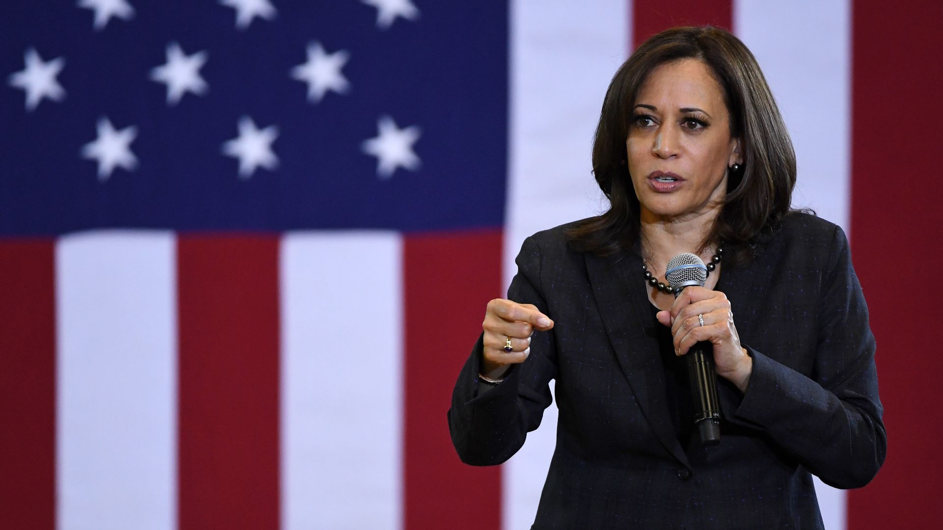 Kamala Harris on stage with a microphone