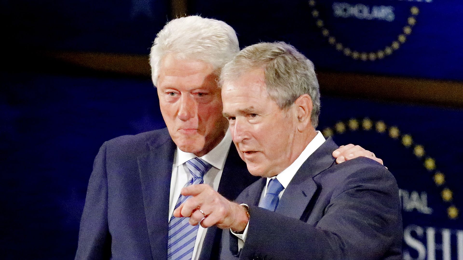 ormer U.S. President George W. Bush (2nd L) shakes hands with former President Bill Clinton 