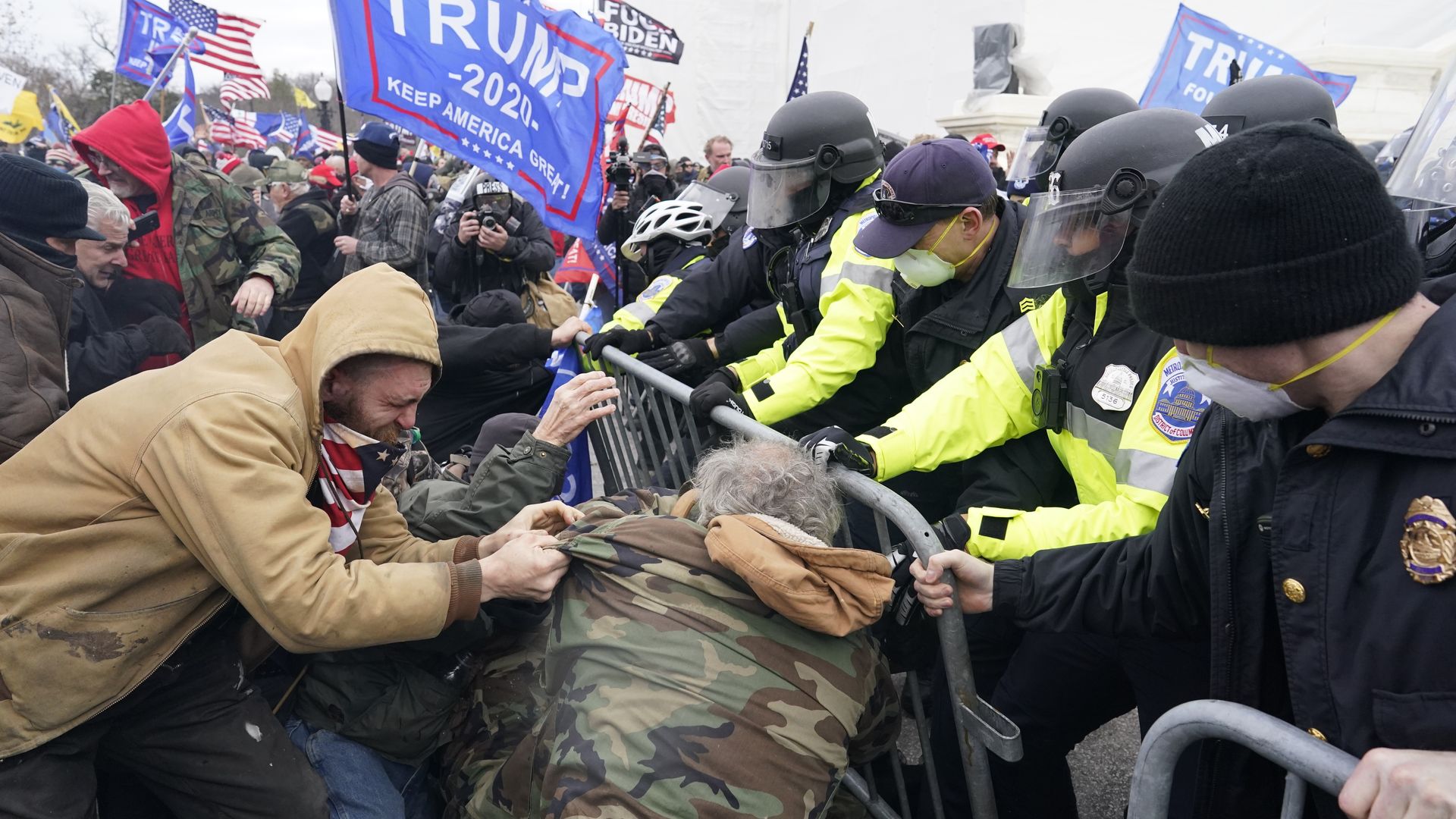Photo of protesters fighting against a police line at the U.S. Capitol during a riot