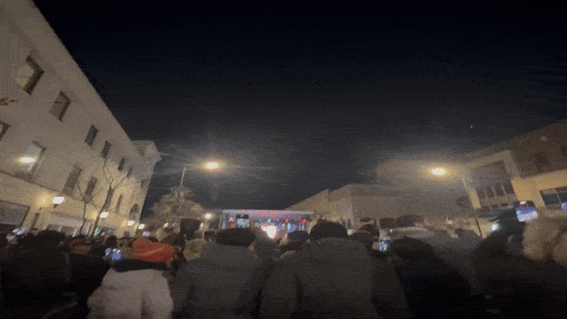 The plaza lights being turned on.