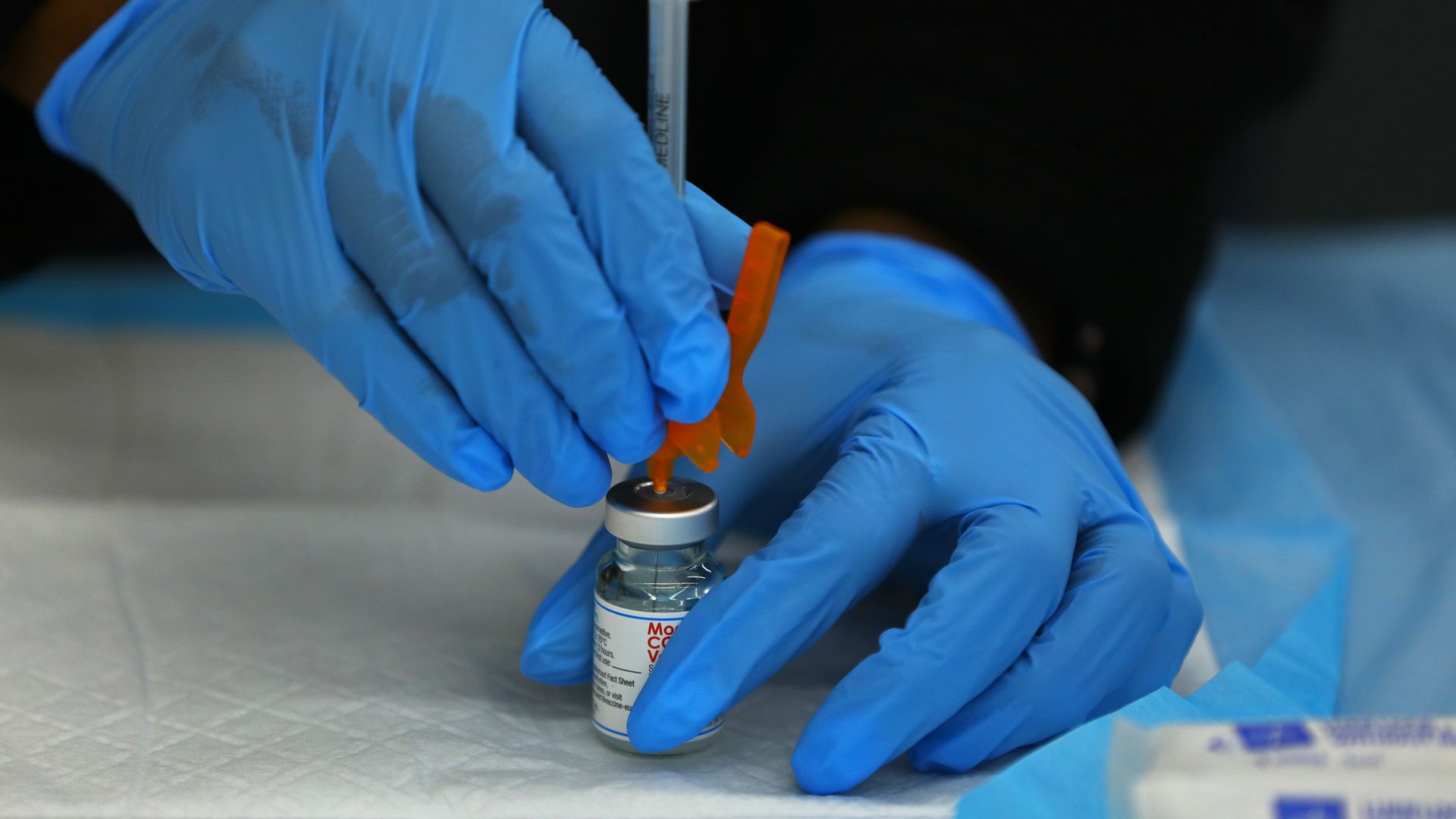 A dose of the Moderna COVID-19 Vaccine is prepared at a COVID-19 testing and vaccination site at the Harvard Street Neighborhood Health Center in Bostons Dorchester on April 5, 2022.